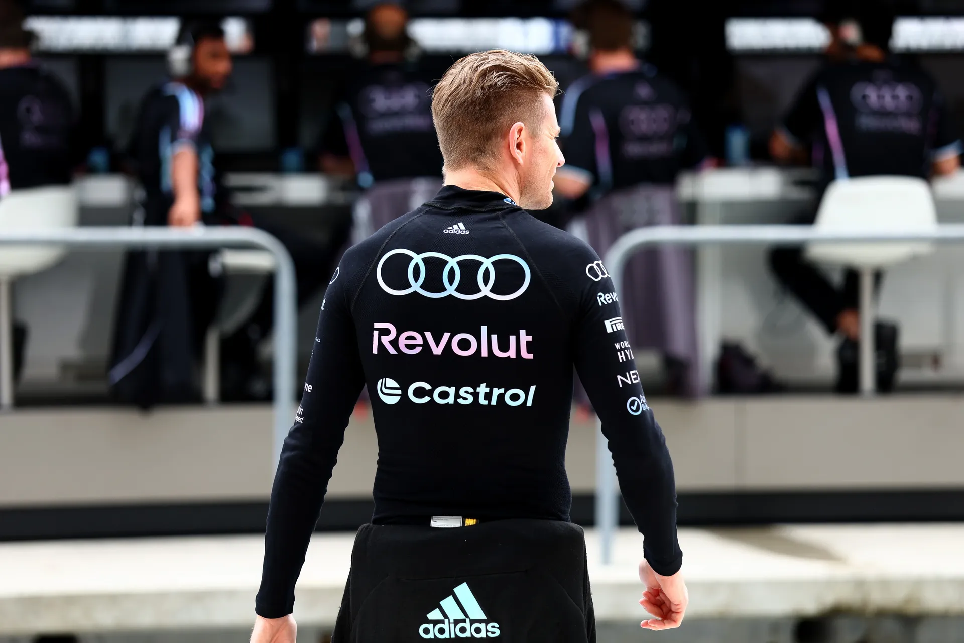 Nico Hulkenberg walks through the Audi Revolut F1® Team paddock in Miami wearing full team kit ahead of the 2026 Grand Prix.