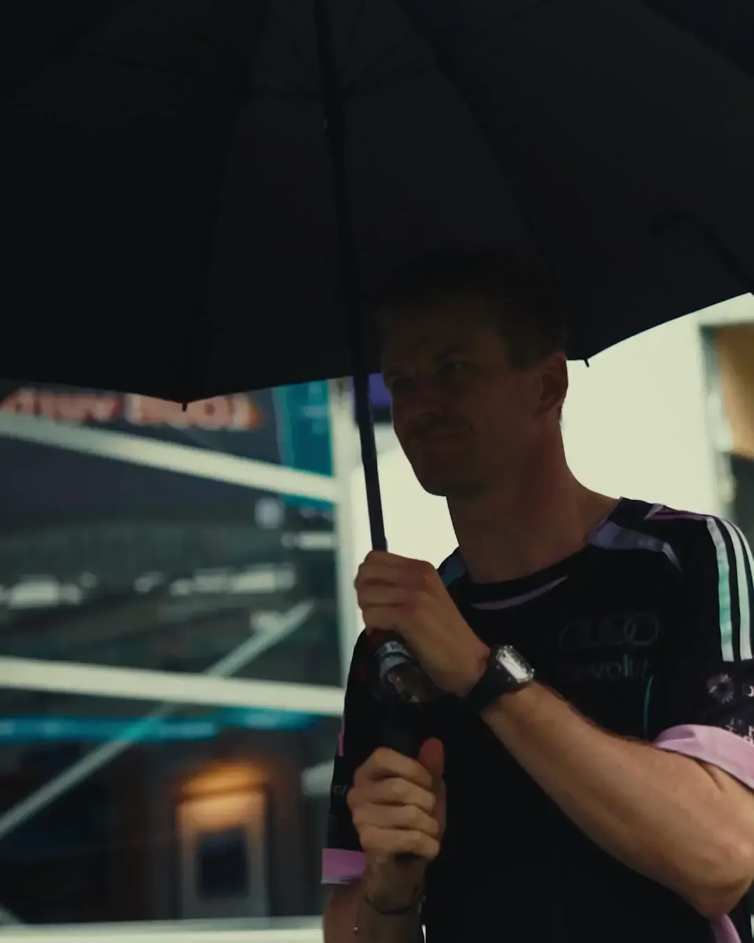 Nico Hulkenberg arrives holding an umbrella in the Miami paddock as Audi Revolut F1® Team prepares for the 2026 Miami Grand Prix.