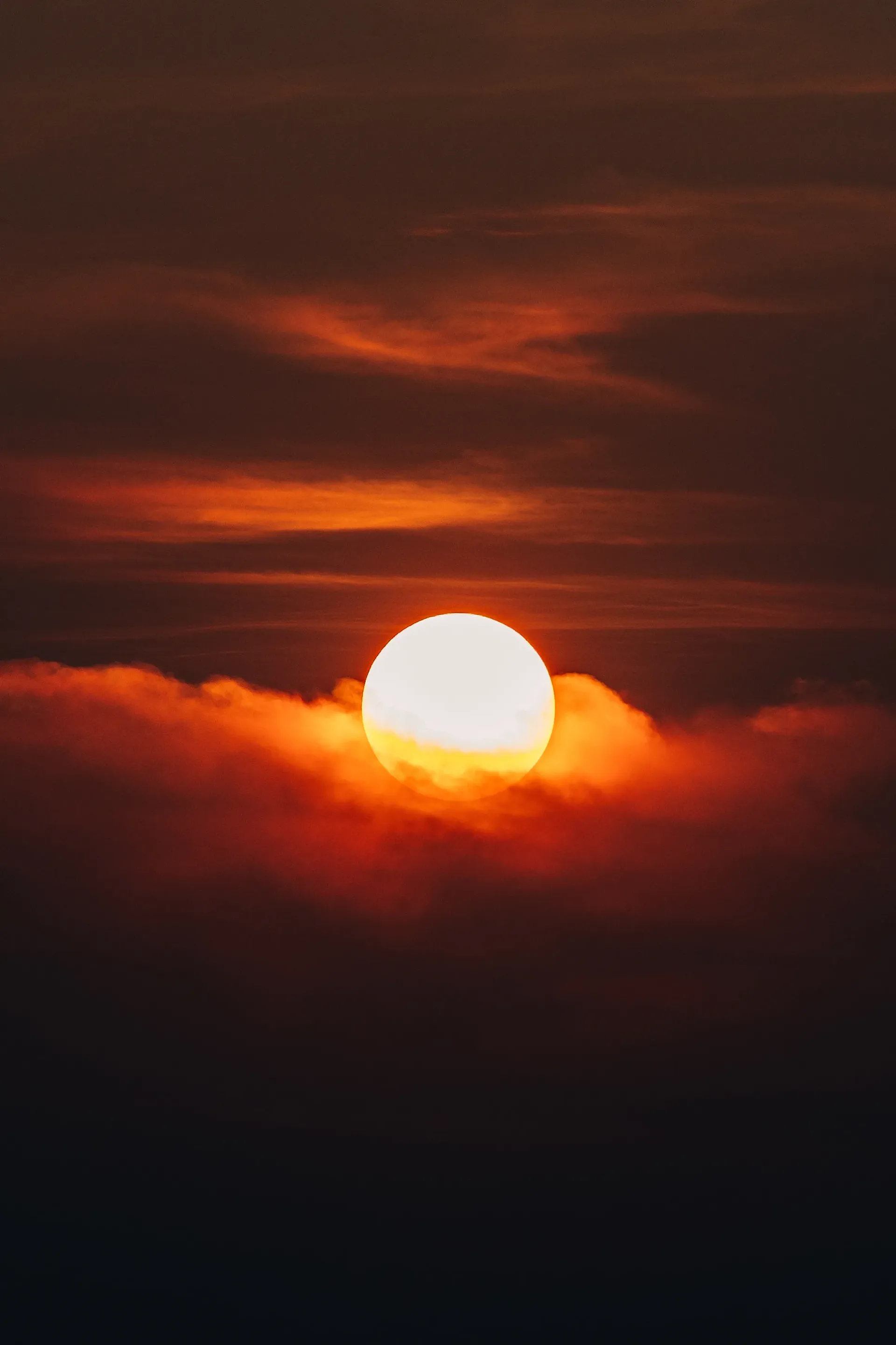 Sun setting behind orange clouds over Kuala Lumpur
