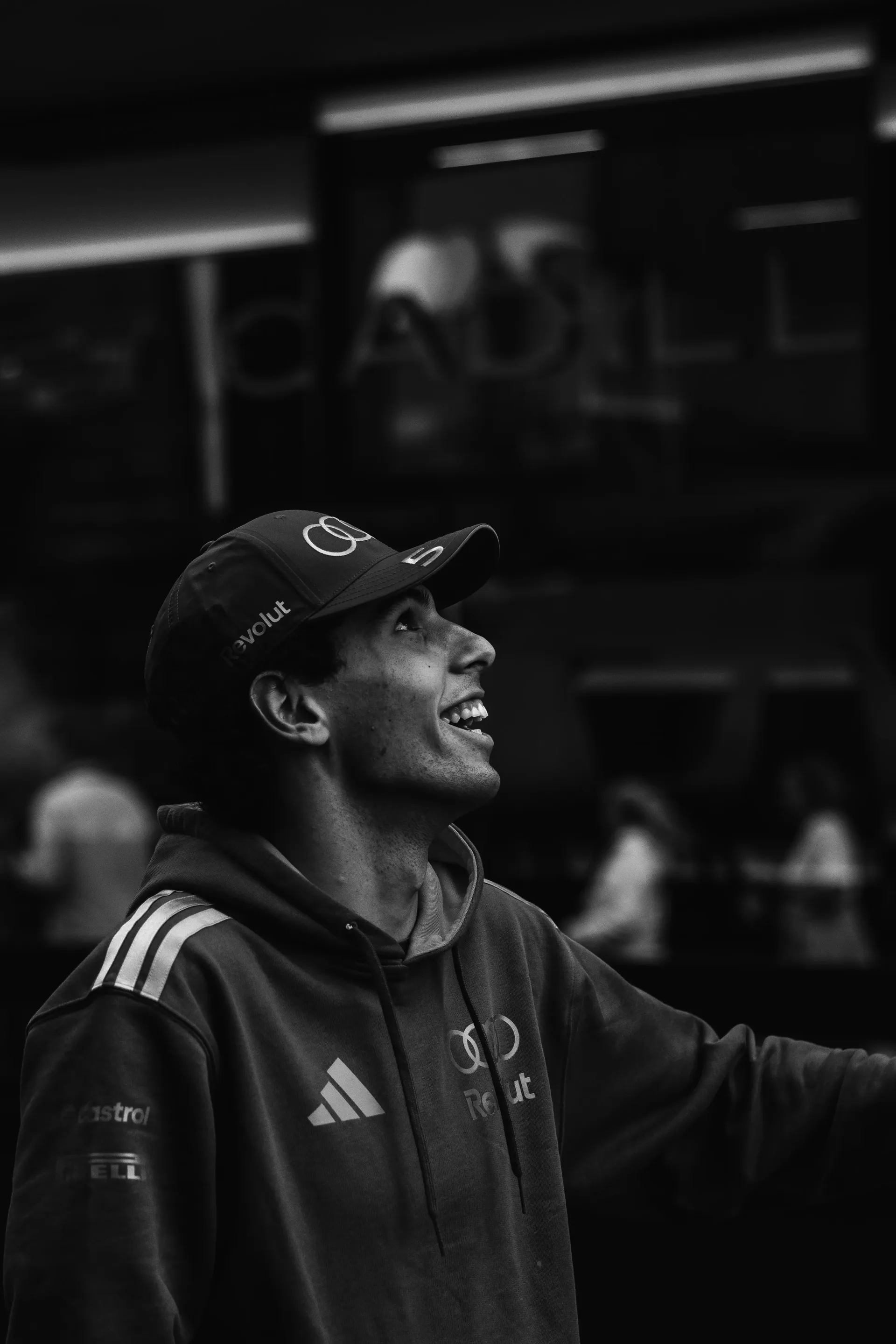 Gabriel Bortoleto laughing in Audi Revolut F1® Team gear at Zandvoort, black and white