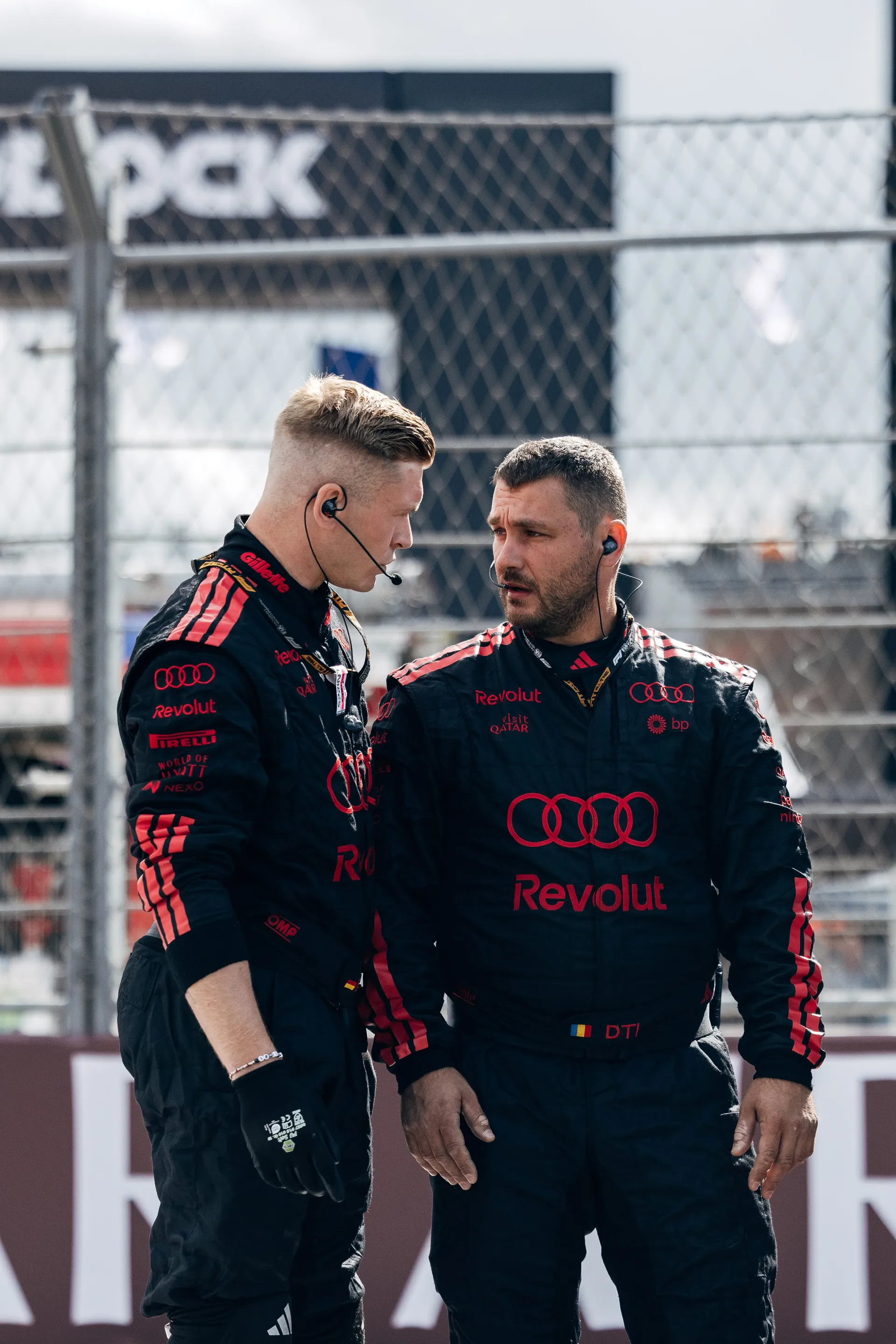 Two Audi Revolut F1® Team crew members talking in the pit lane at Zandvoort