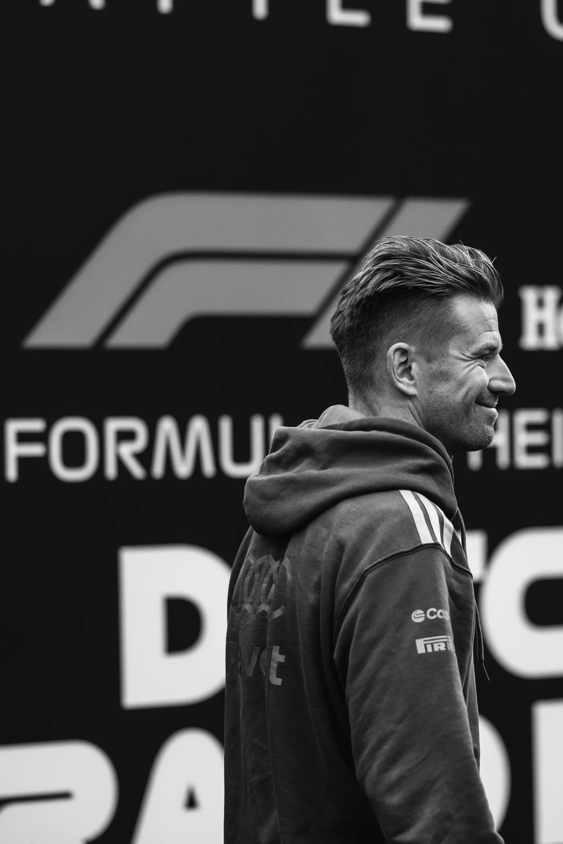 Nico Hulkenberg in profile in front of the Formula 1 logo at Zandvoort, black and white