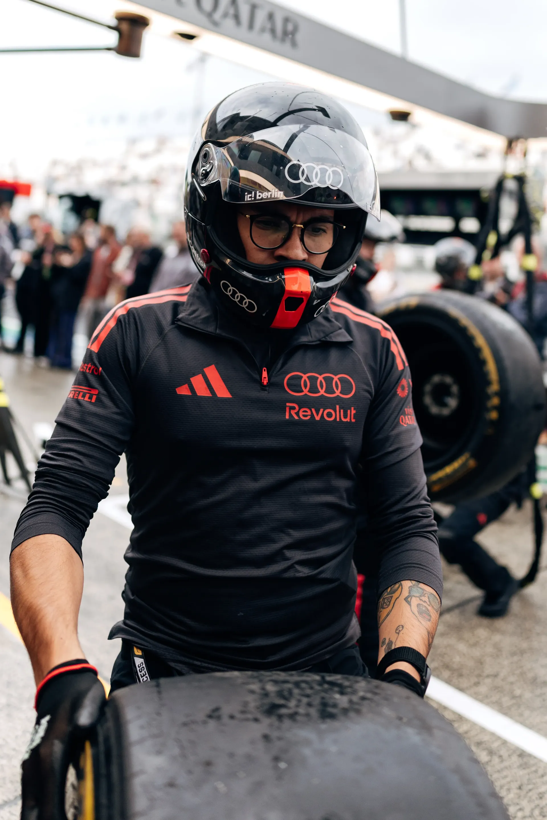 Audi Revolut F1® Team mechanic moving a tyre in the pit lane at Zandvoort