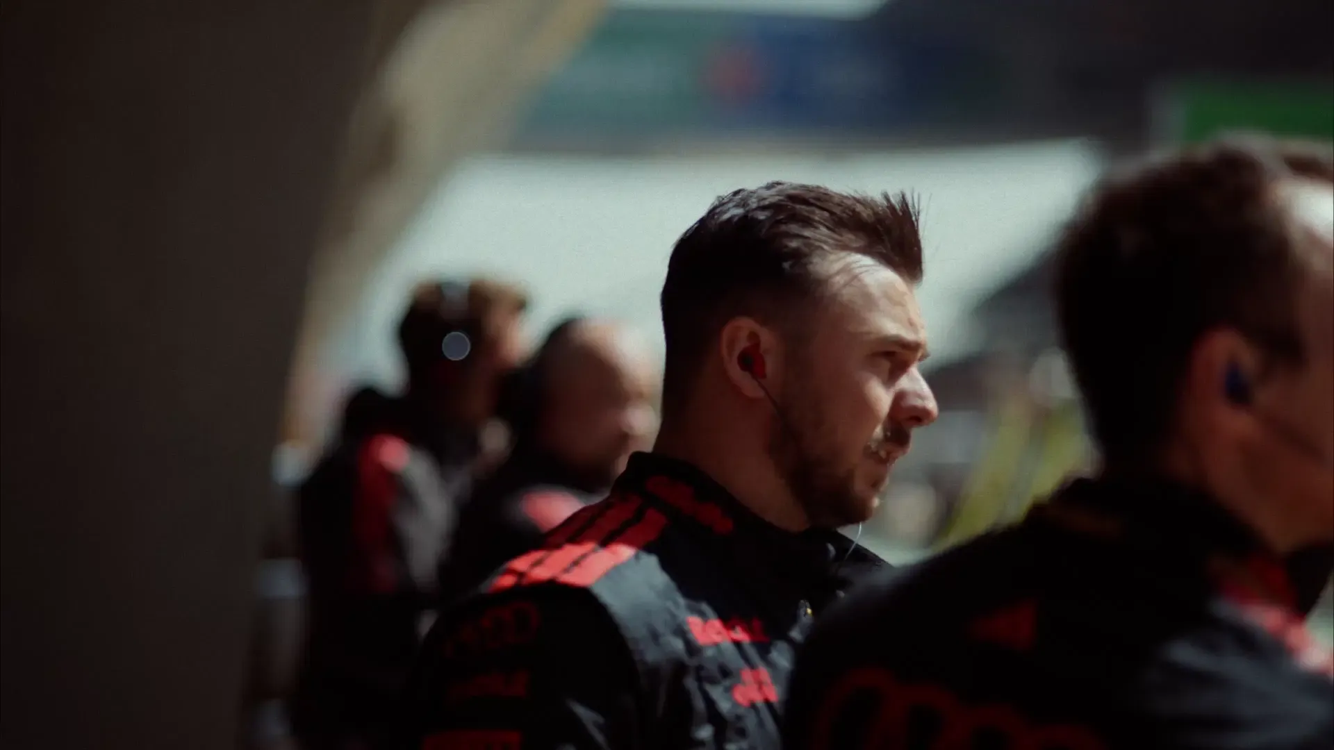Close up of mechanics crew of the Audi Revolut F1® Team at the Chinese Grand Prix in Shanghai standing at the aedge of the racetrack and communicating