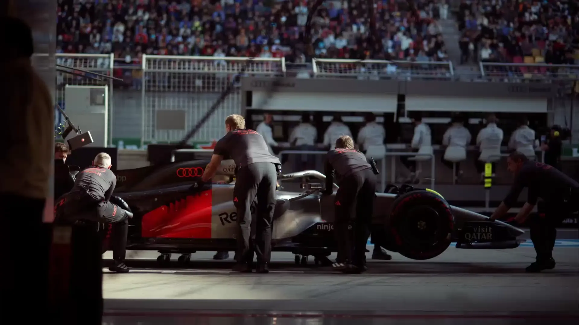 Crew members of the Audi Revolut F1® Team at the Chinese Grand Prix racetrack in Shanghai catching the R26 car