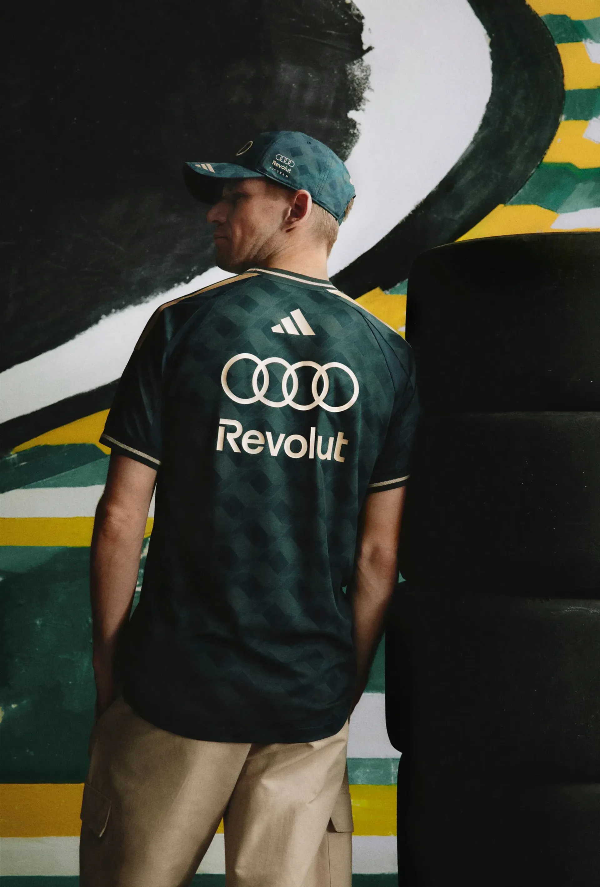 Rear view of a model in the adidas x Audi Revolut F1® Team São Paulo jersey with Audi rings and Revolut on the back