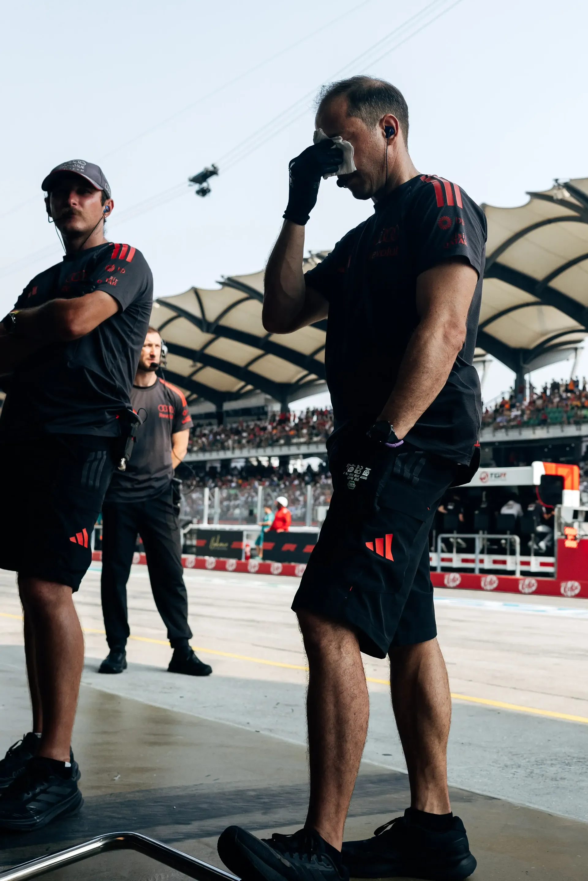 Audi Revolut F1® Team members standing together in the Singapore paddock.