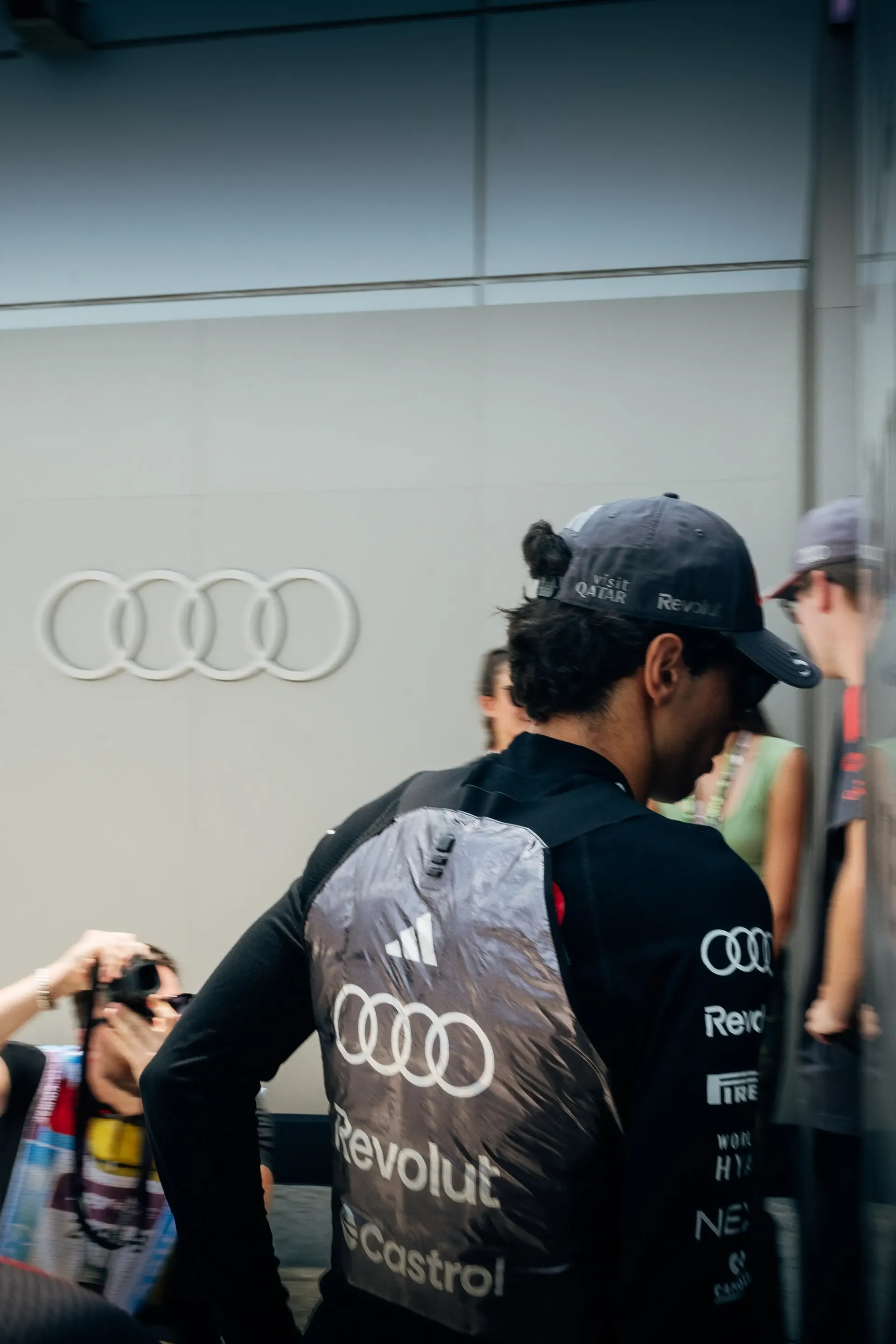 Audi Revolut F1® Team member seen from behind in teamwear in the paddock.