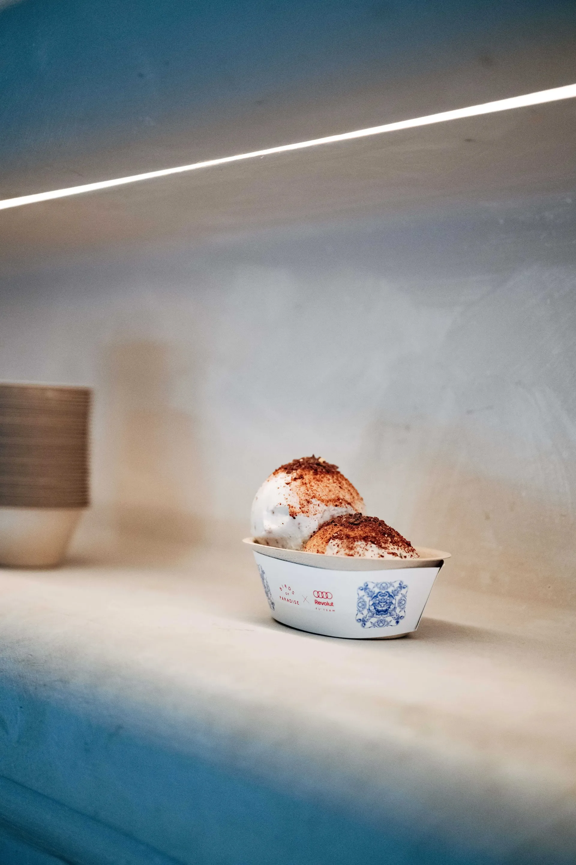 Audi Revolut F1® Team Singapore GP Burnt Ends collaboration, image with a co branded cup