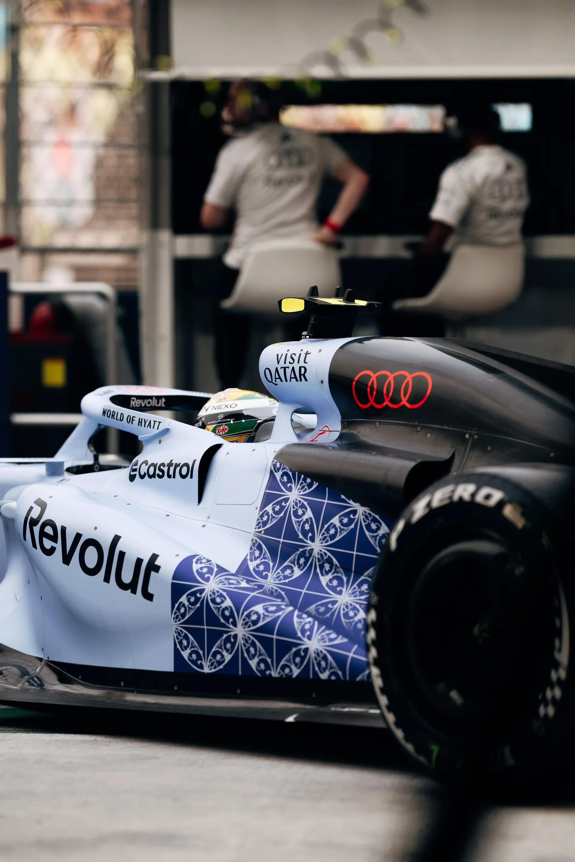 Gabriel Bortoleto in the cockpit of the Audi Revolut F1® Team car R26 in the pit lane, engineers on the pit wall behind.