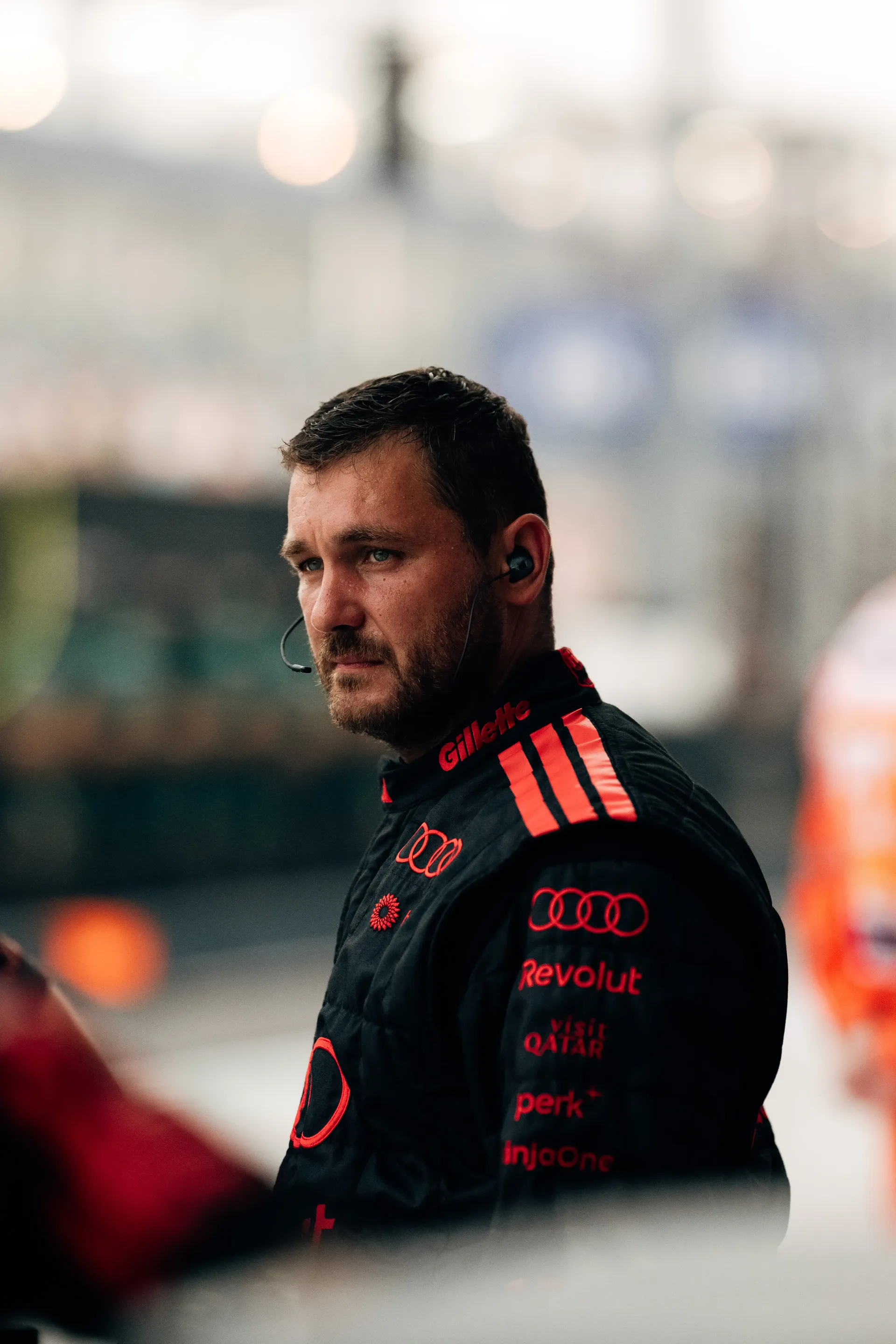 Audi Revolut F1® Team mechanic in the pit lane, looking to the side.
