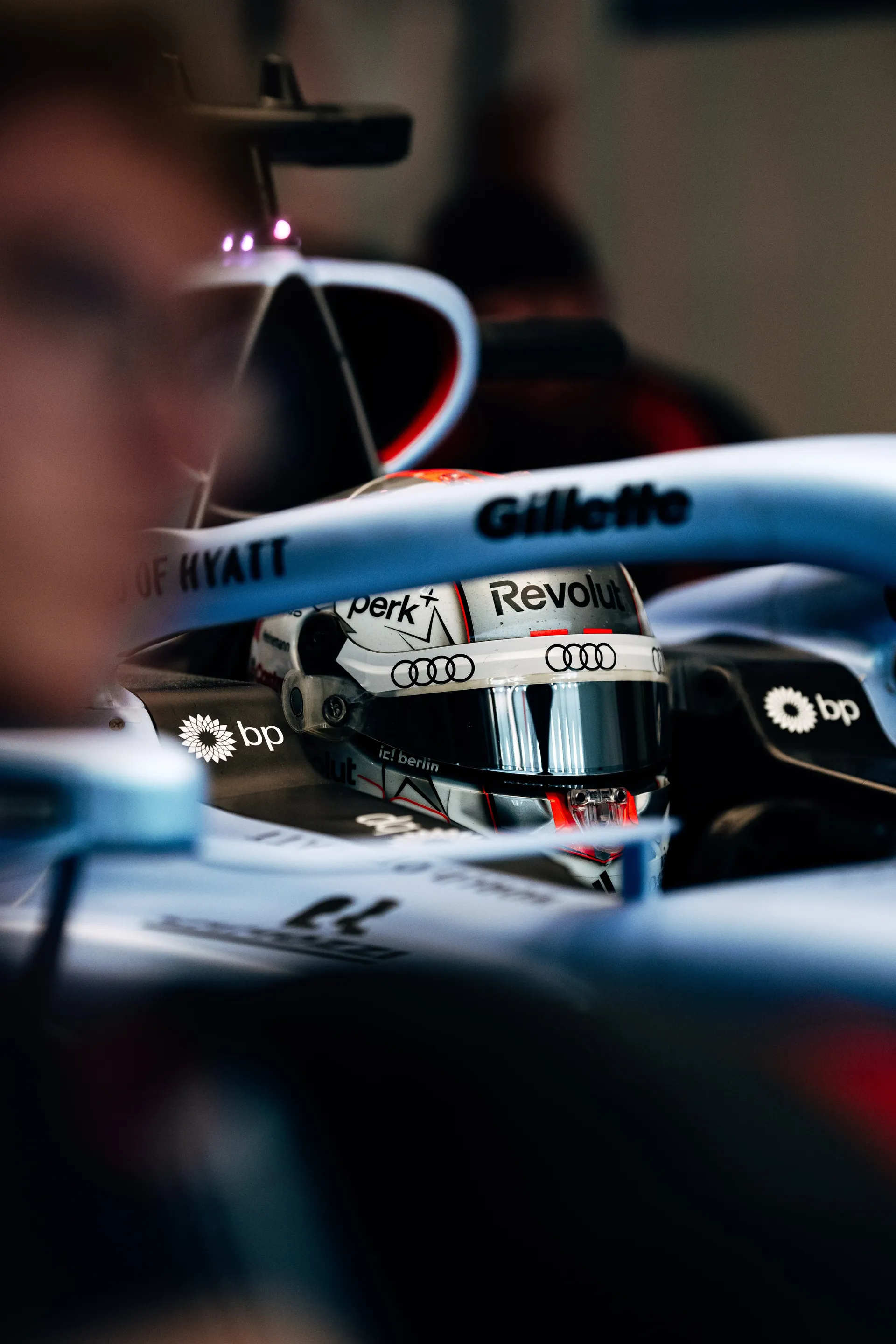 Nico Hulkenberg seated in the cockpit of the Audi Revolut F1® Team car, helmet on beneath the halo.