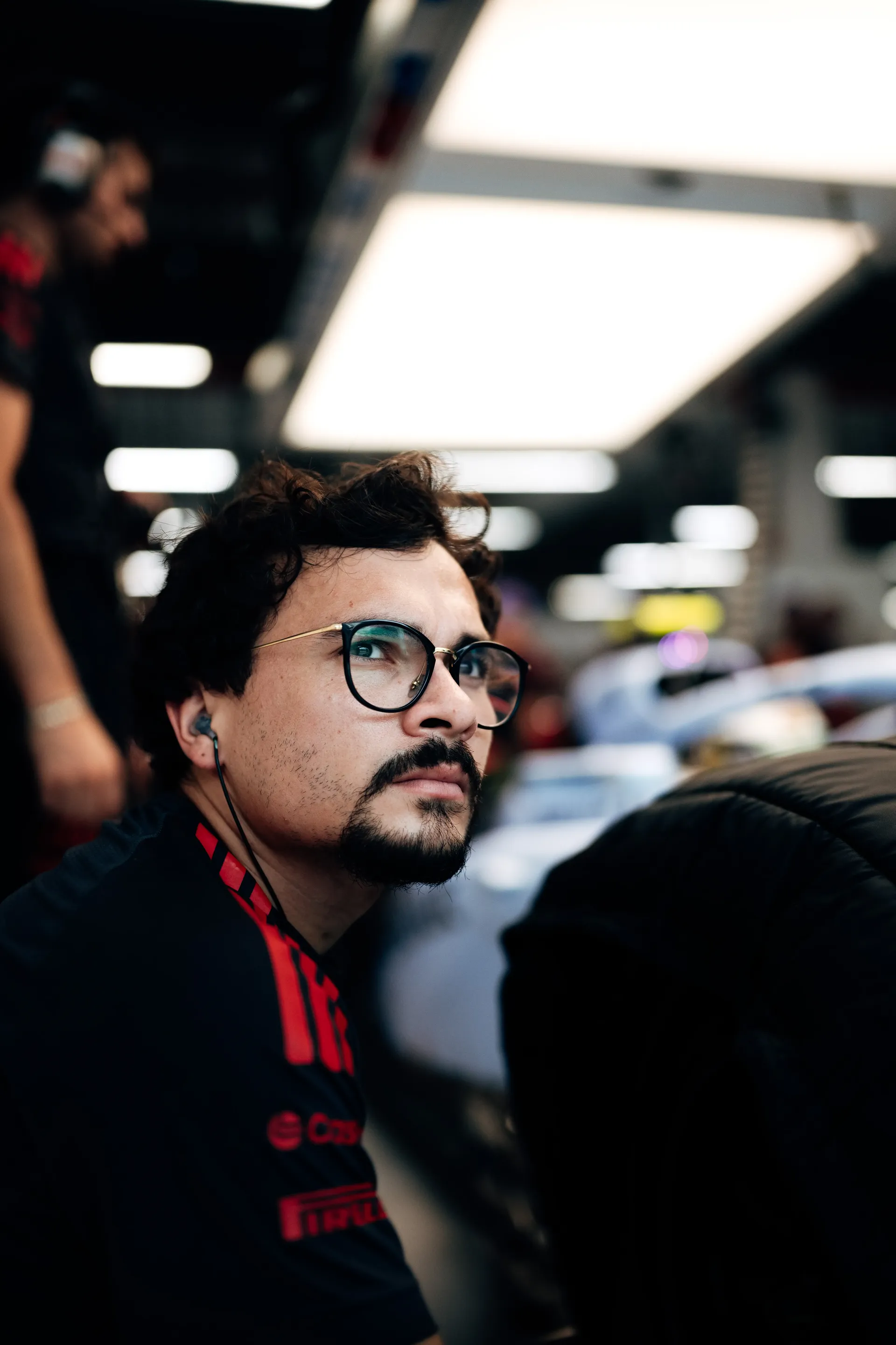 Audi Revolut F1® Team mechanic with glasses and a beard in the garage.