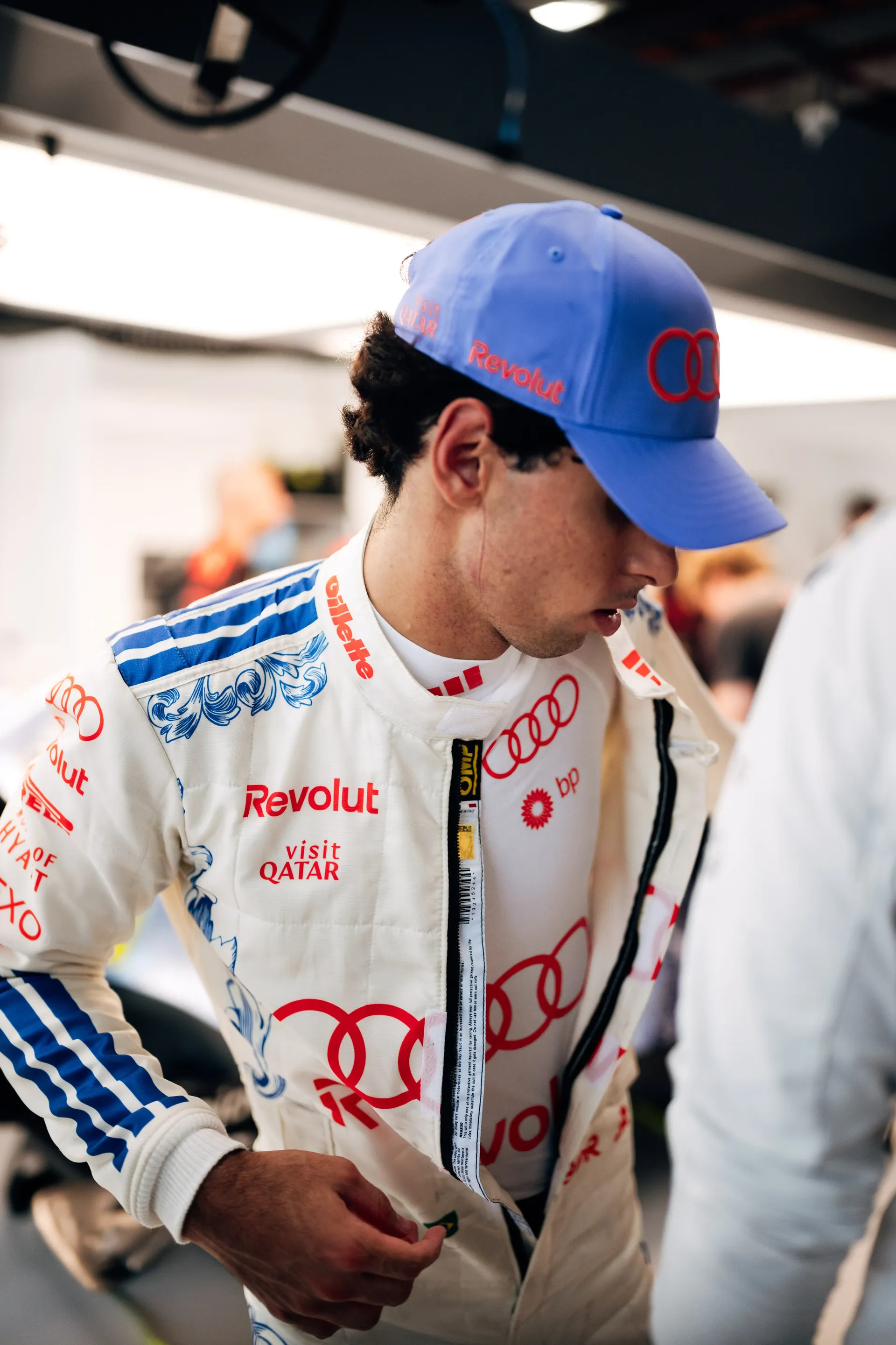 Gabriel Bortoleto driver at Audi Revolut F1® Team race boots with his number 27 on a blue tile pattern, below his white race suit.