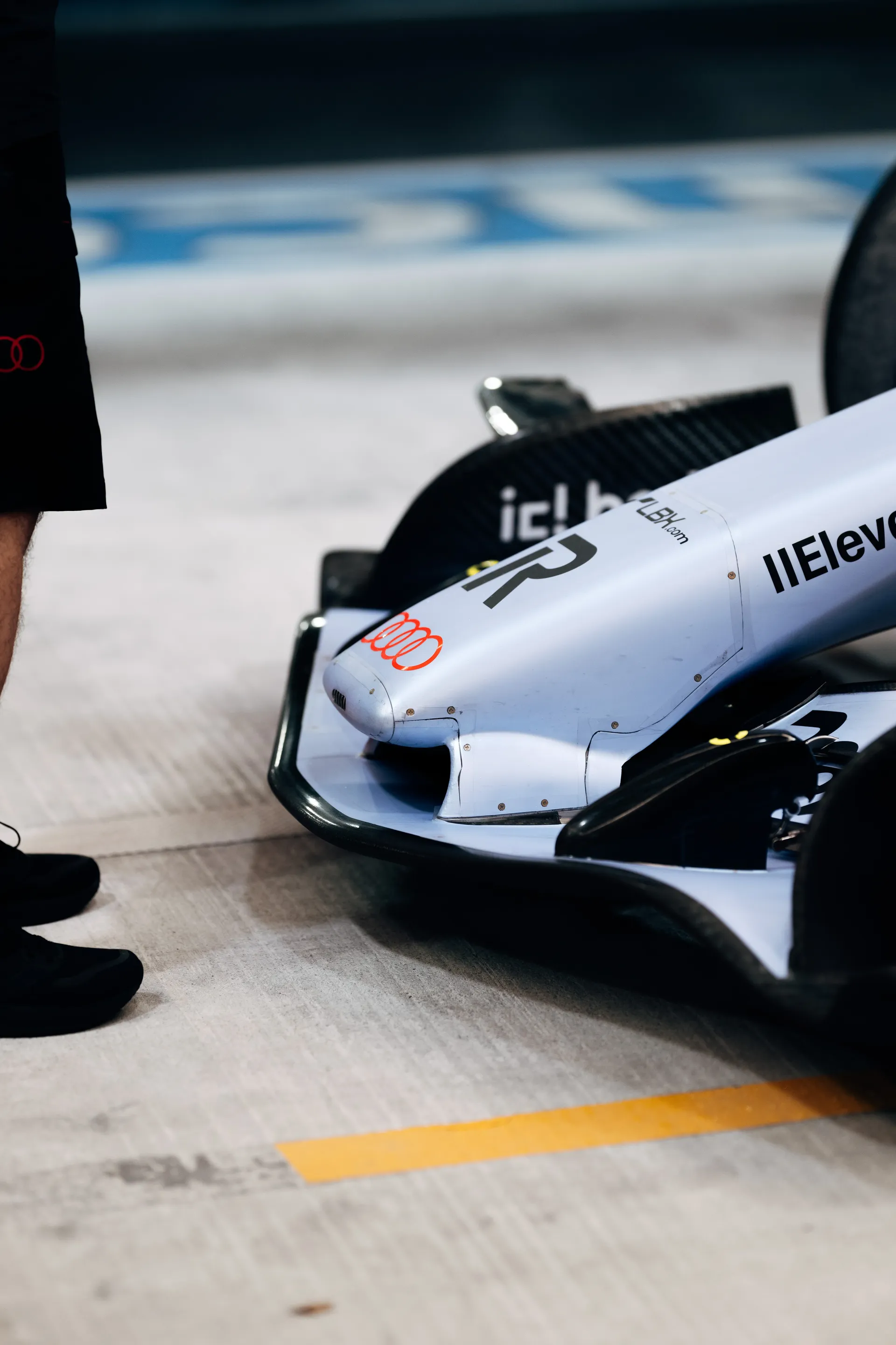 Front of the Audi Revolut F1® Team car R26 in its silver special livery in the pit lane.