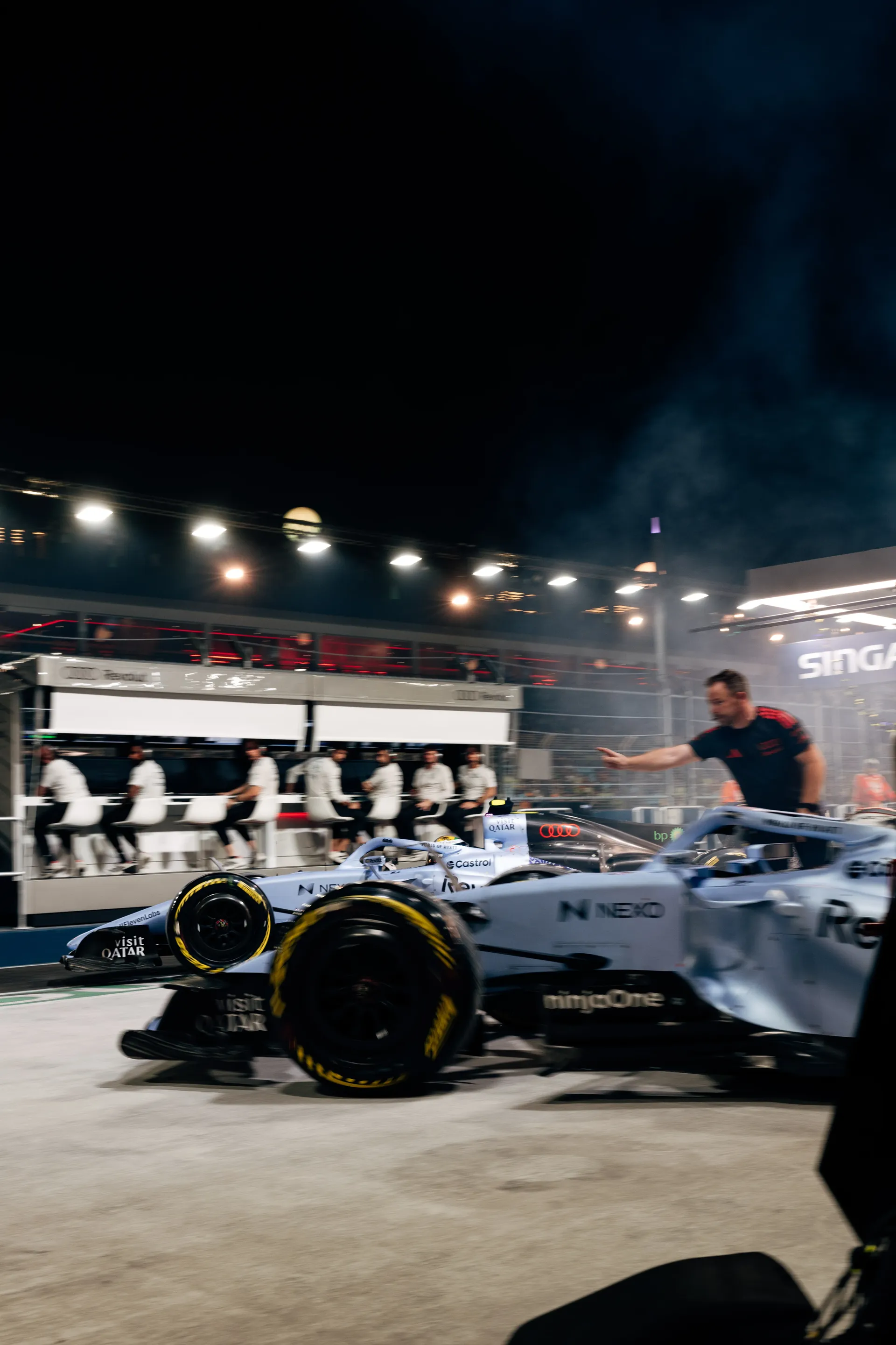 The Audi Revolut F1® Team car R26 in the pit lane under the Marina Bay floodlights.