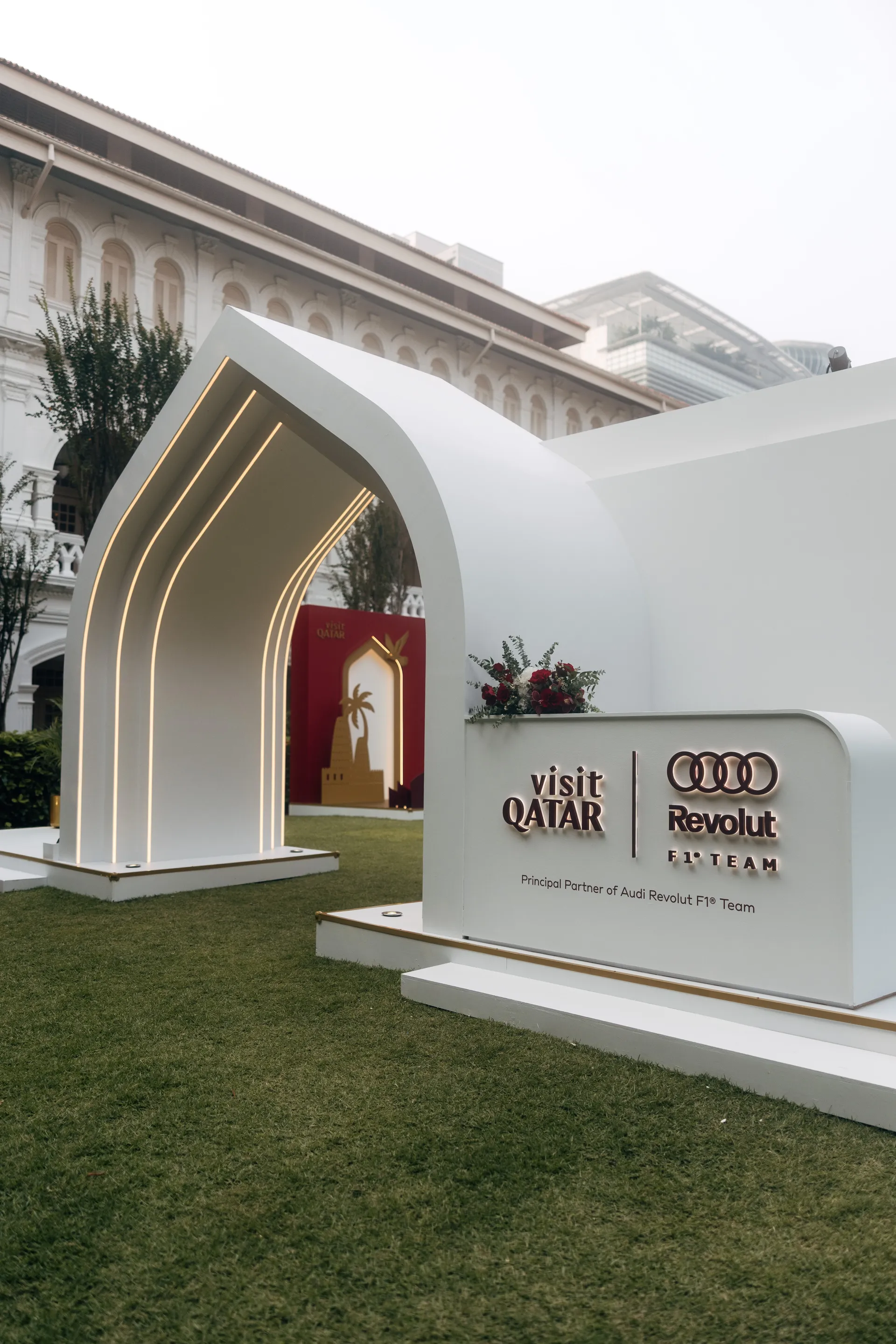 White architectural arch with illuminated curved light strips.