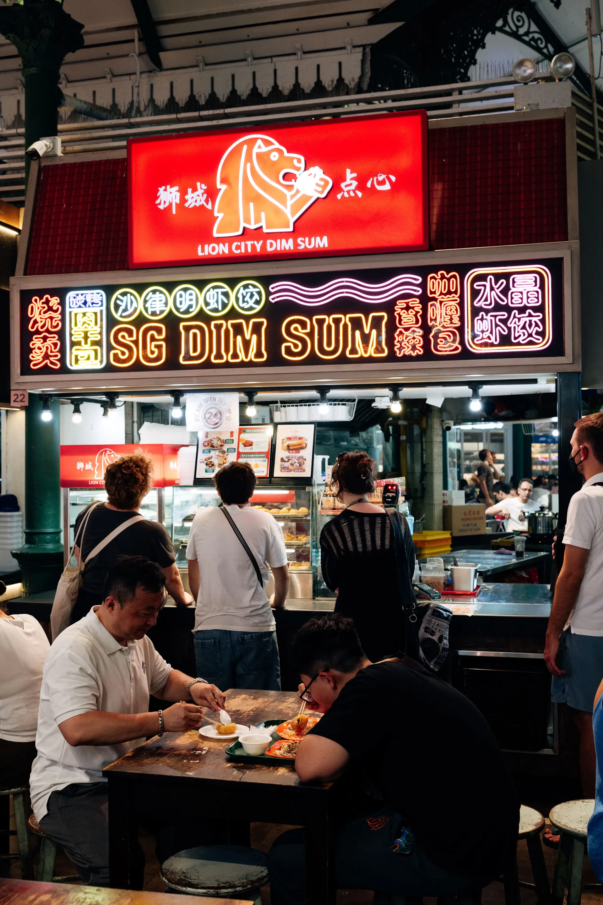 Busy Singapore food stall with diners
