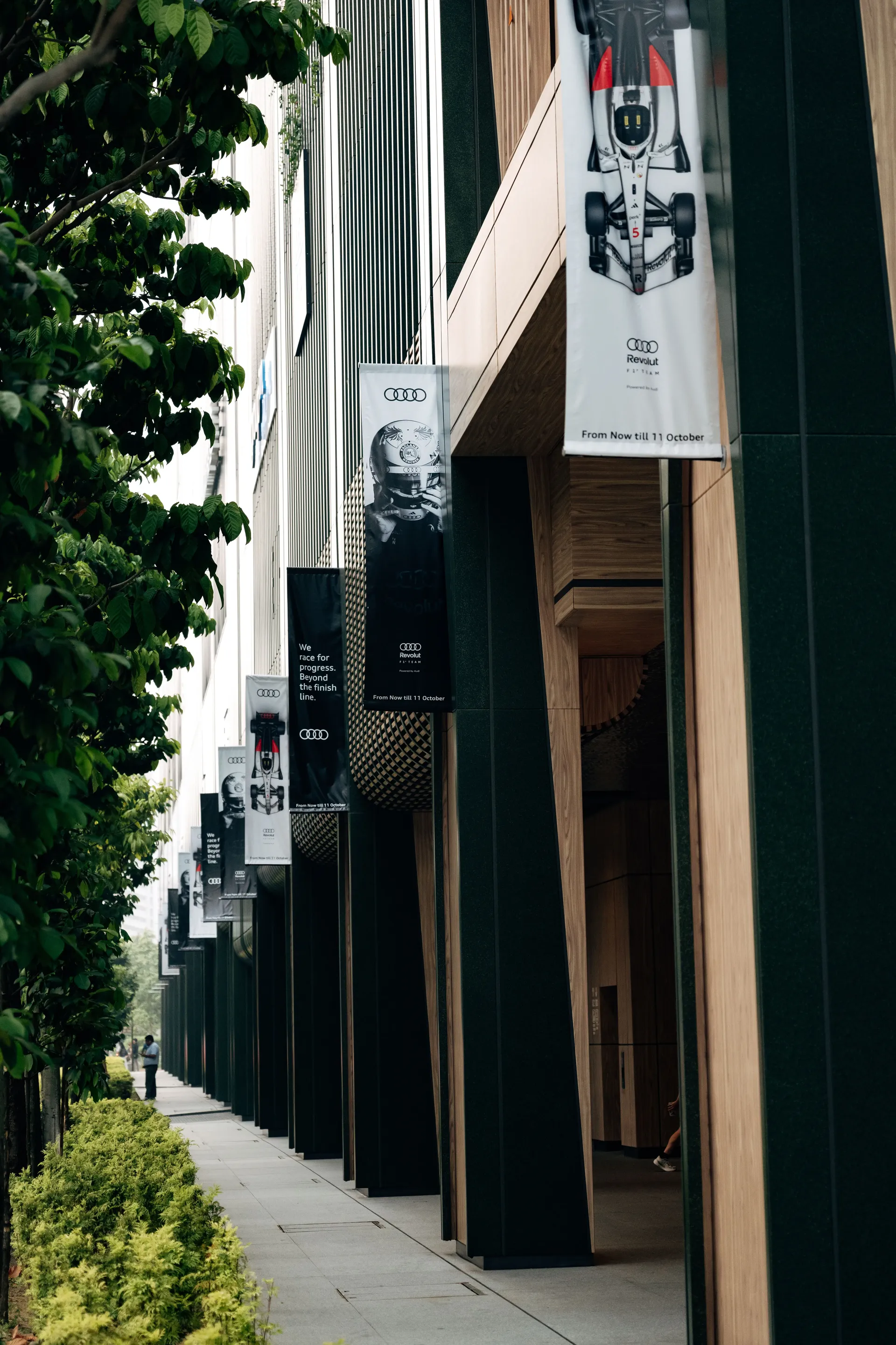 Singapore street with modern storefronts and greenery