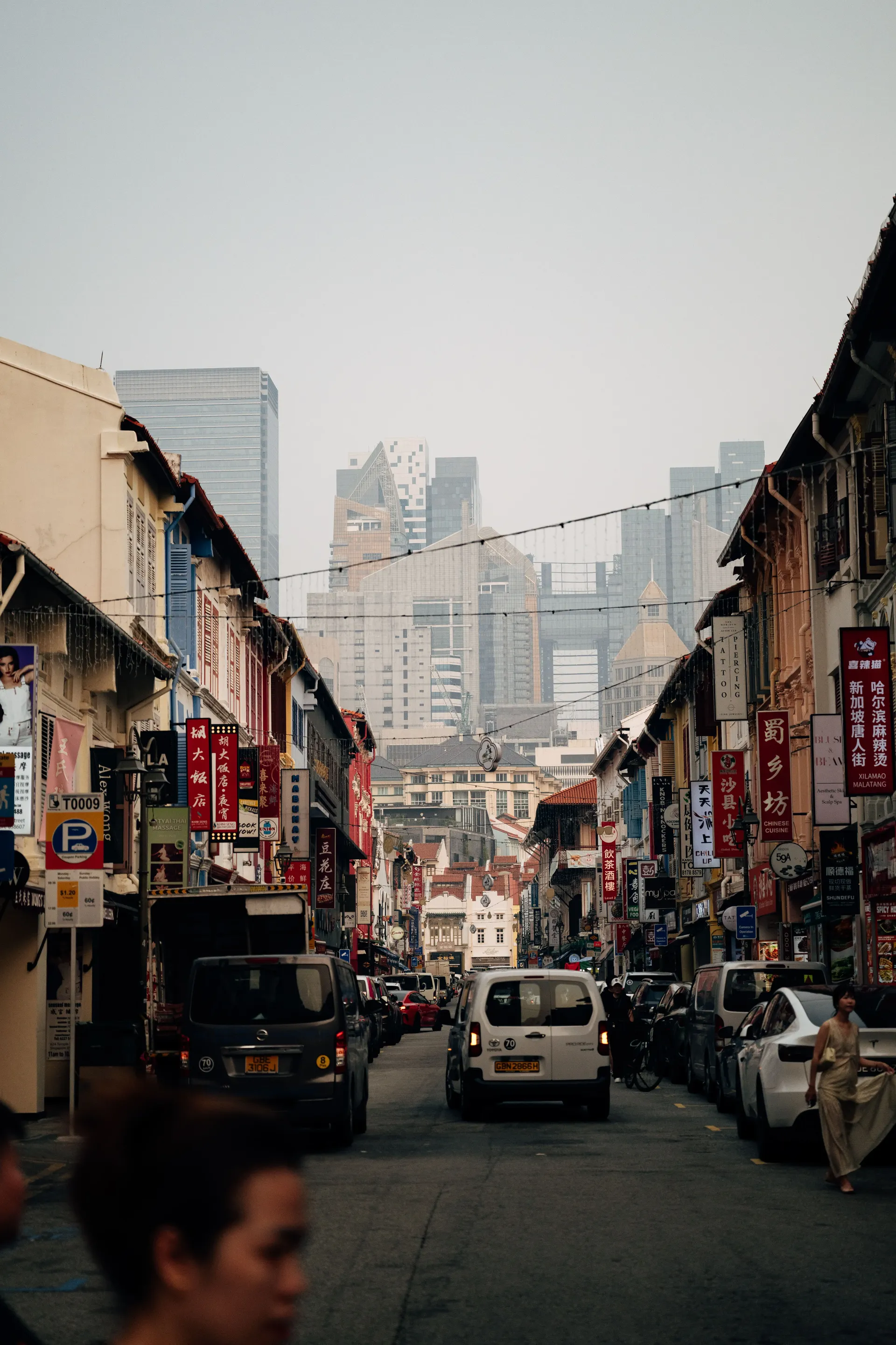 Singapore street with traditional shophouses and high-rise buildings