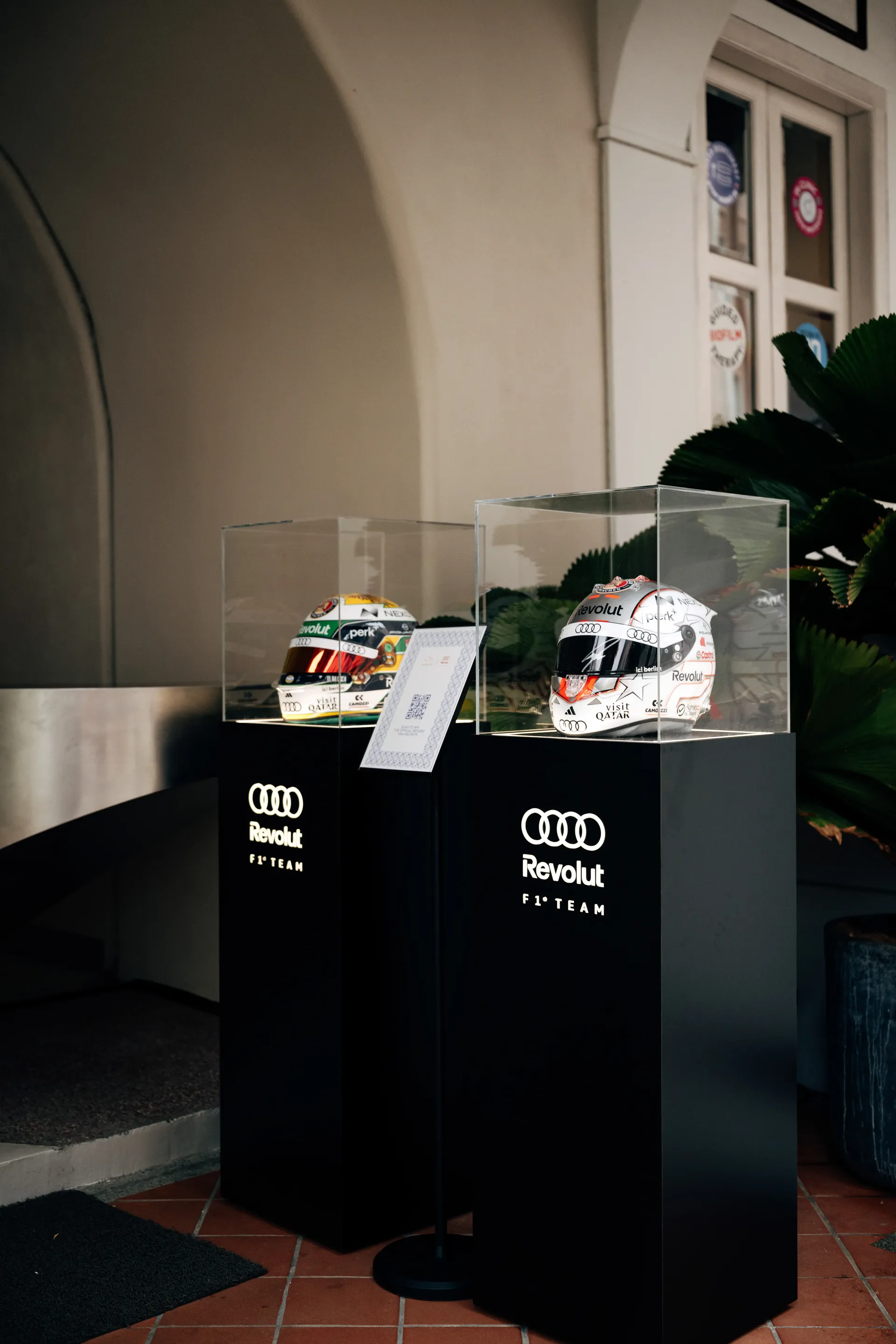 Audi display with racing helmets and branded materials