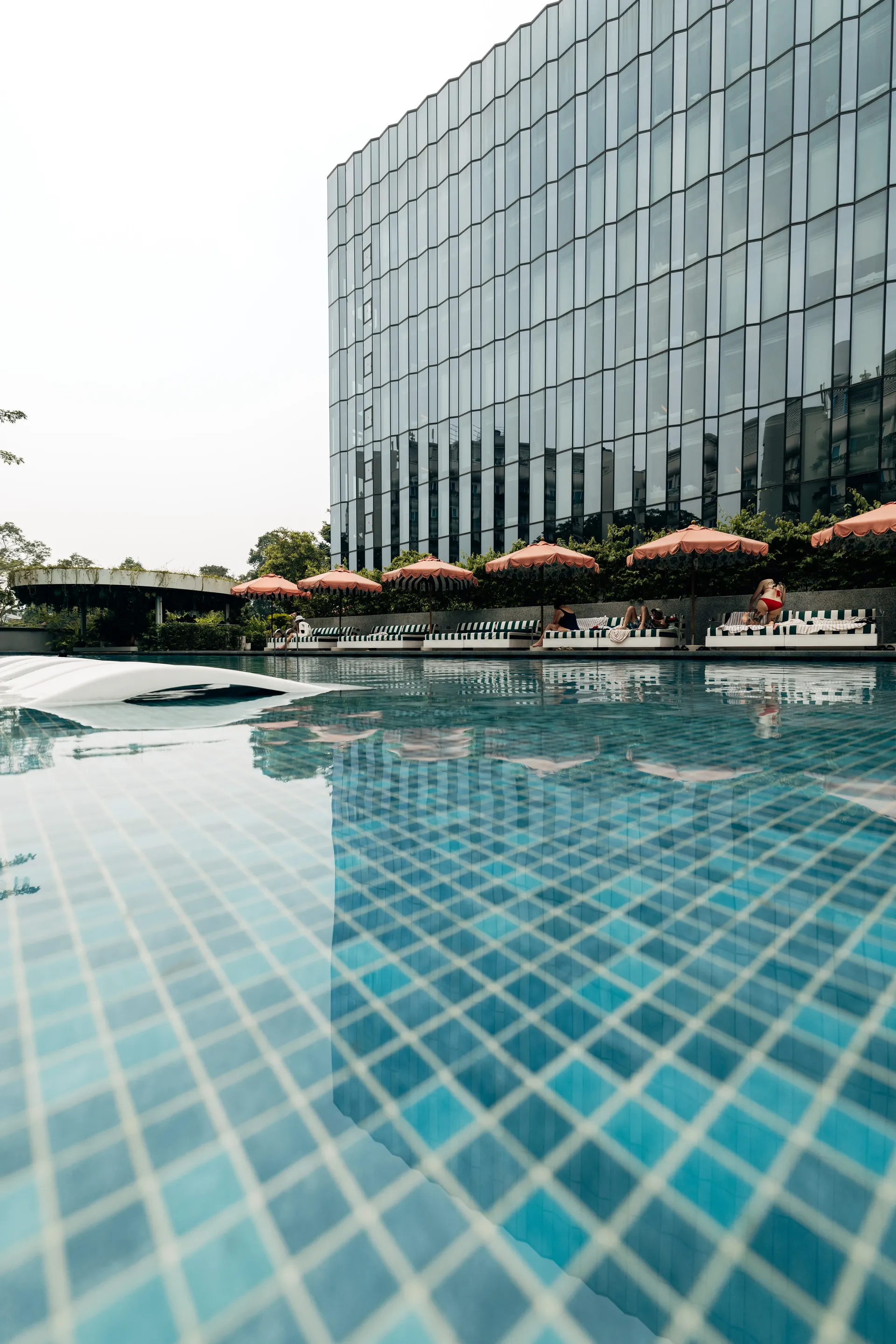 Outdoor swimming pool overlooking a modern Singapore building