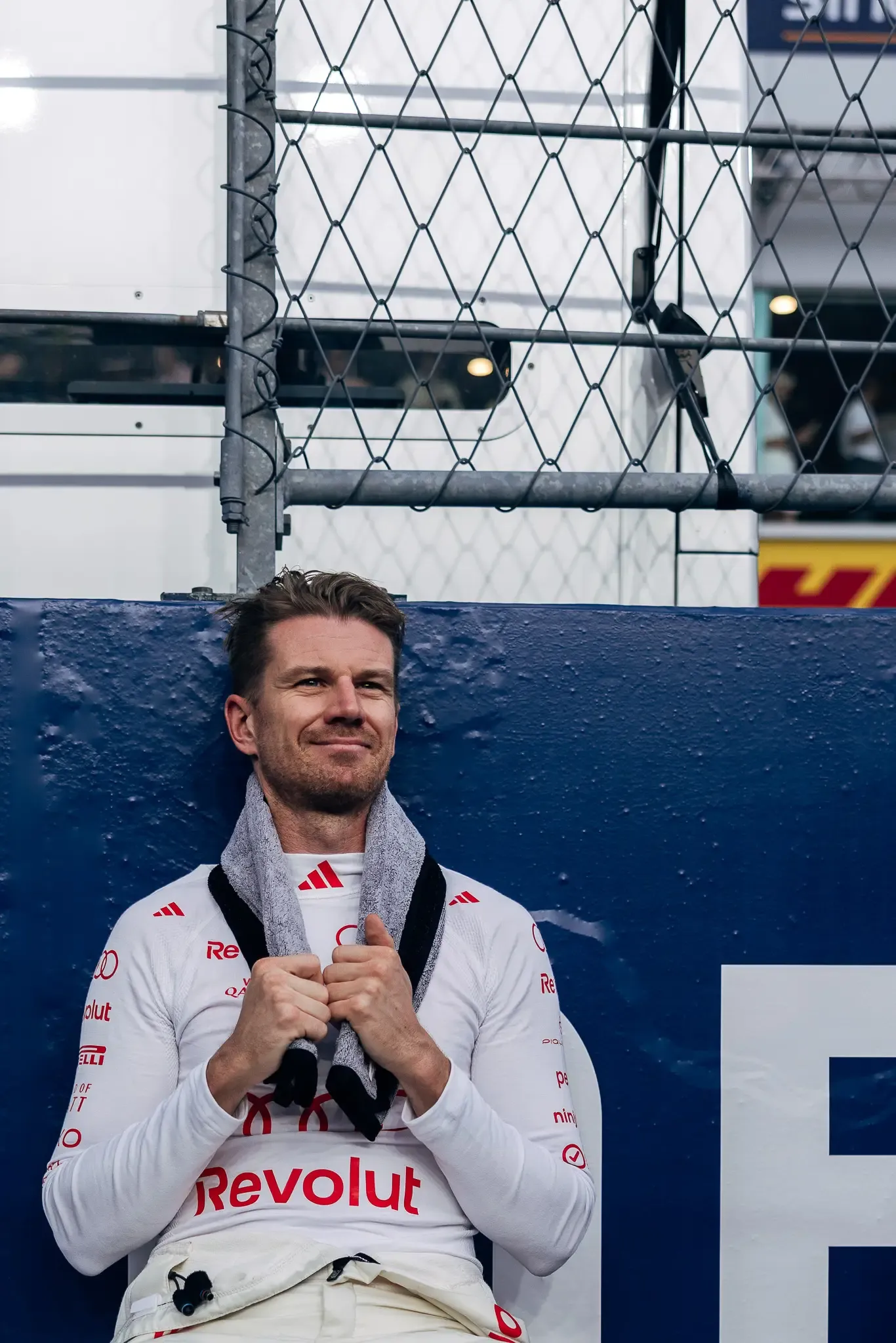 Audi Revolut F1® Team driver Nico Hülkenberg leaning against a barrier.