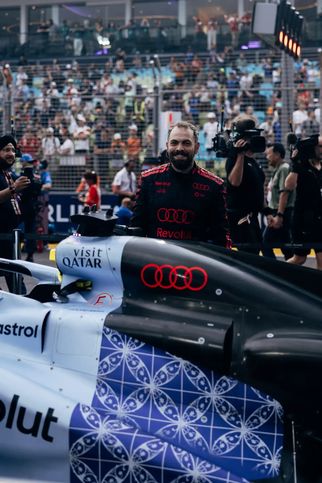 Audi Revolut F1® Team car on the grid with mechanics.