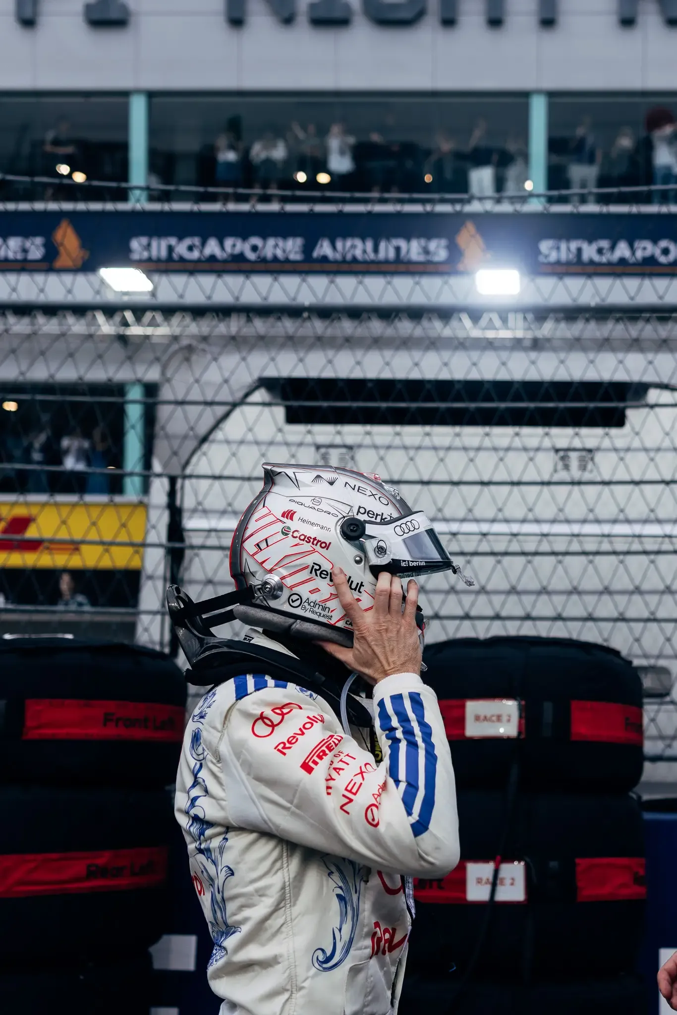 Audi Revolut F1® Team driver Nico Hülkenberg putting on his helmet.