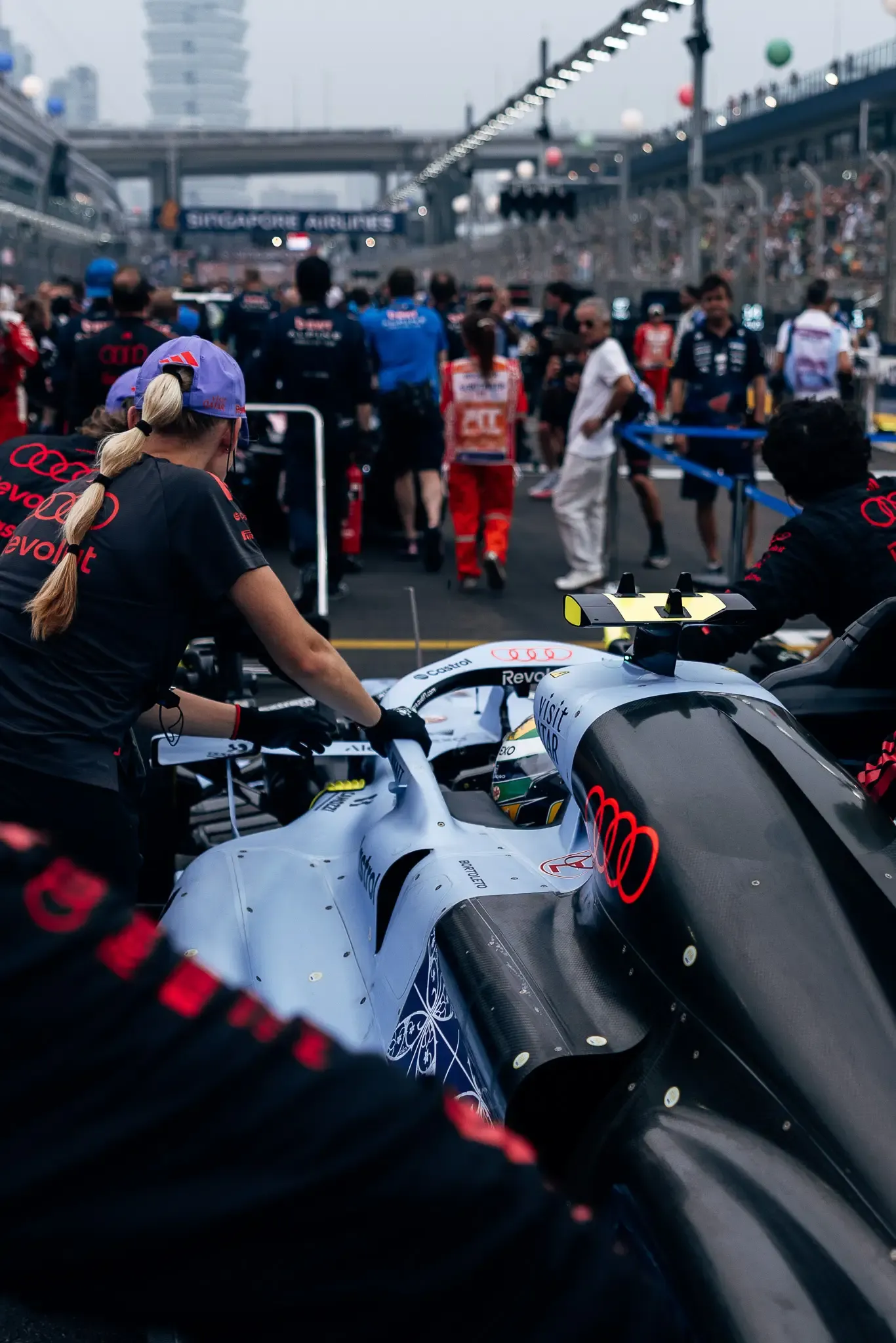 Audi Revolut F1® Team mechanics around the car on the grid.