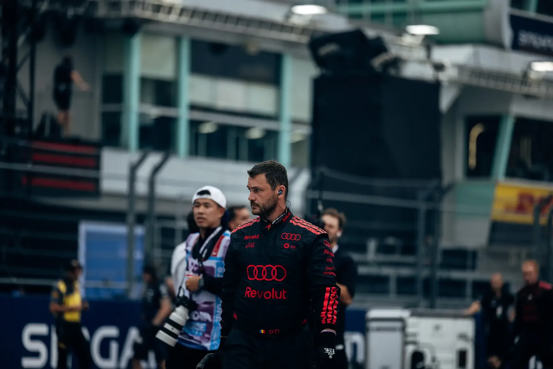 Audi Revolut F1® Team mechanic walking across the grid.