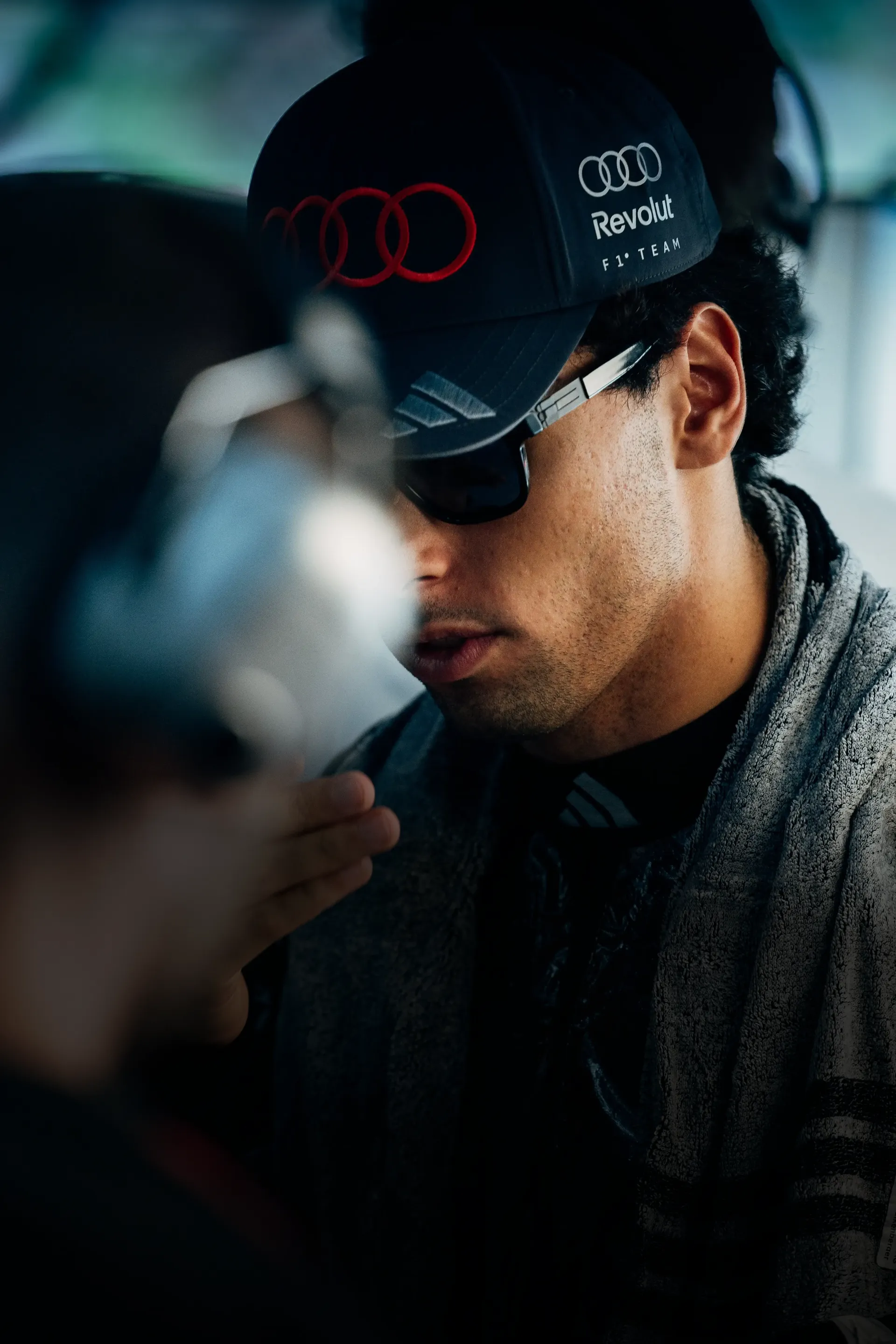 Close up of Audi Revolut F1® Team driver Gabriel Bortoleto inside the garage sweating
