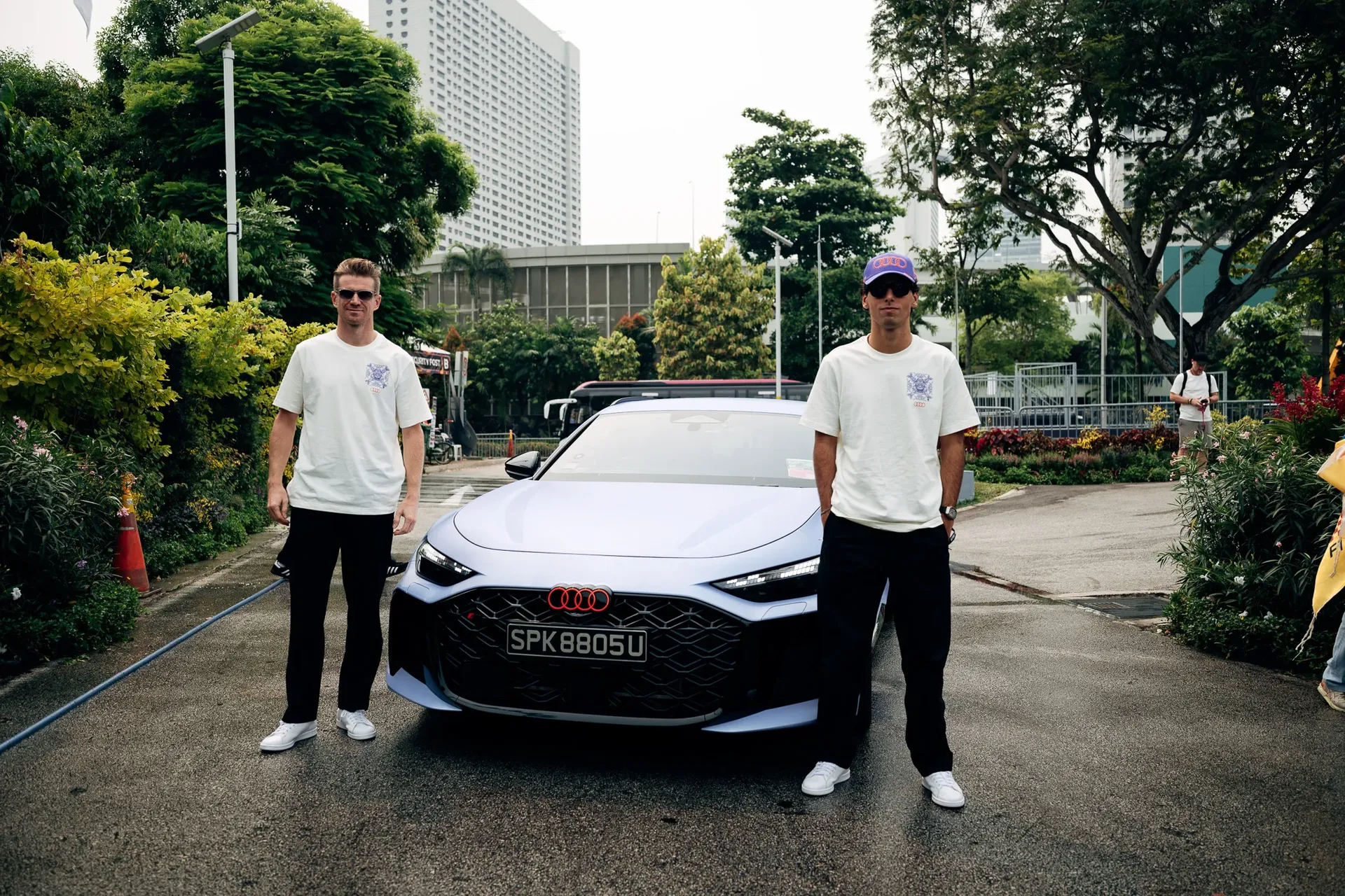 Nico Hulkenberg and Gabriel Bortoleto, drivers of the Audi Revolut F1® Team, posing beside a car in Singapore.