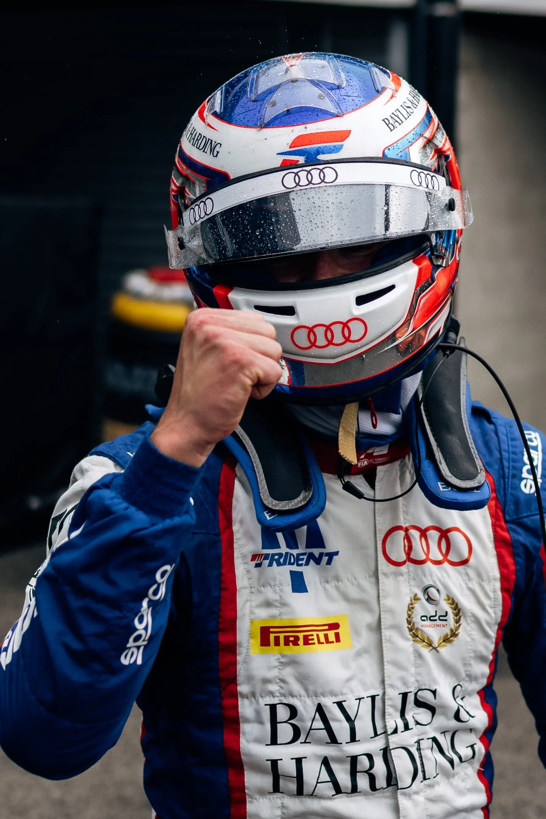 Freddie Slater in a rain-flecked helmet with a clenched fist at Spa-Francorchamps