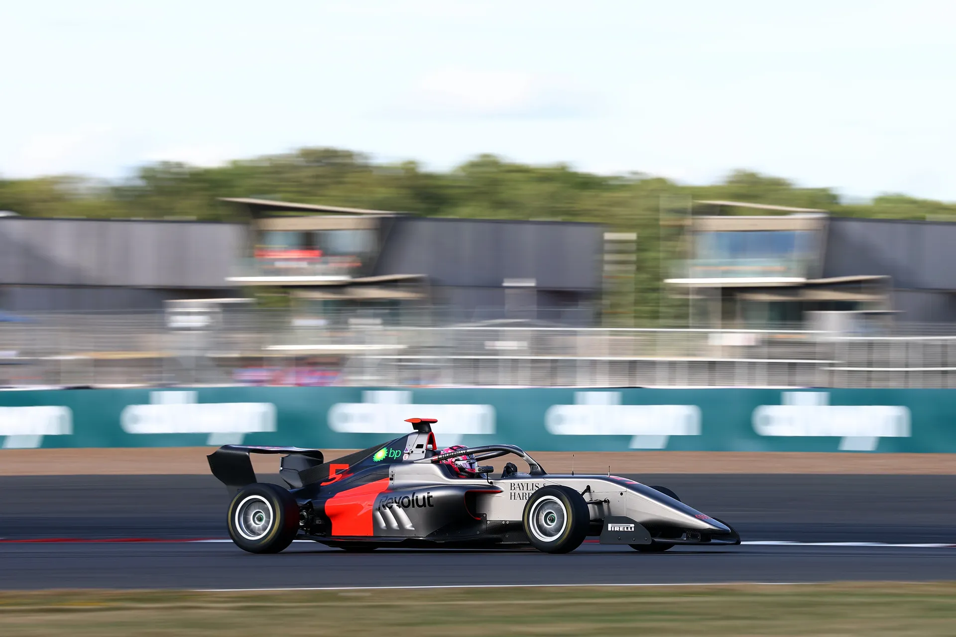 Audi Revolut F1® Team F1 Academy car #5 drives at speed on track with motion blur in the background, highlighting performance and pace.