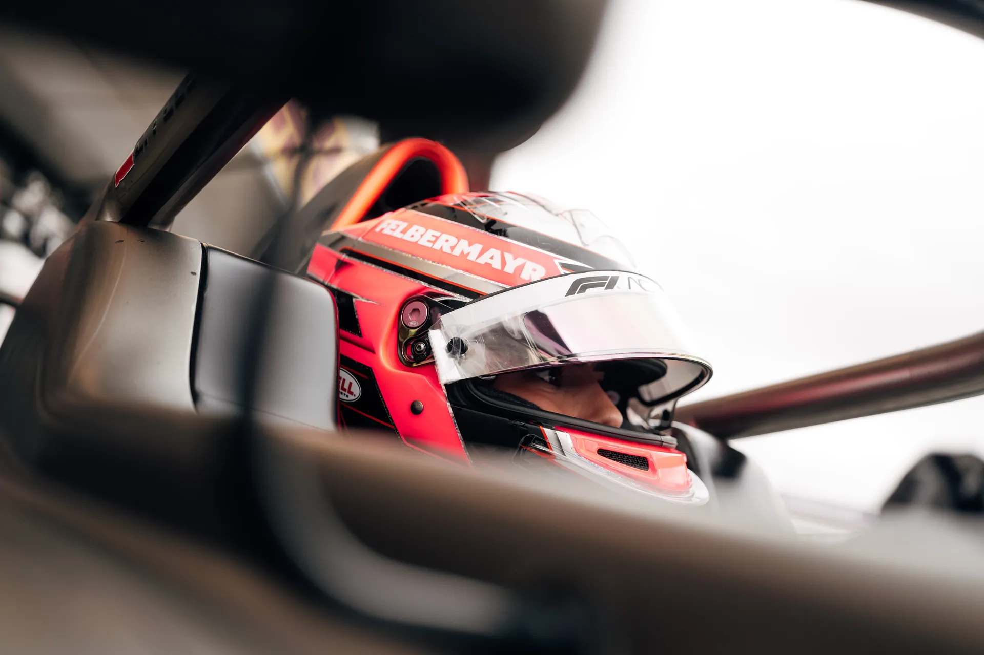 Close-up of a driver’s eye visible through a helmet visor inside the cockpit of an Audi Revolut F1® Team F1 Academy car.