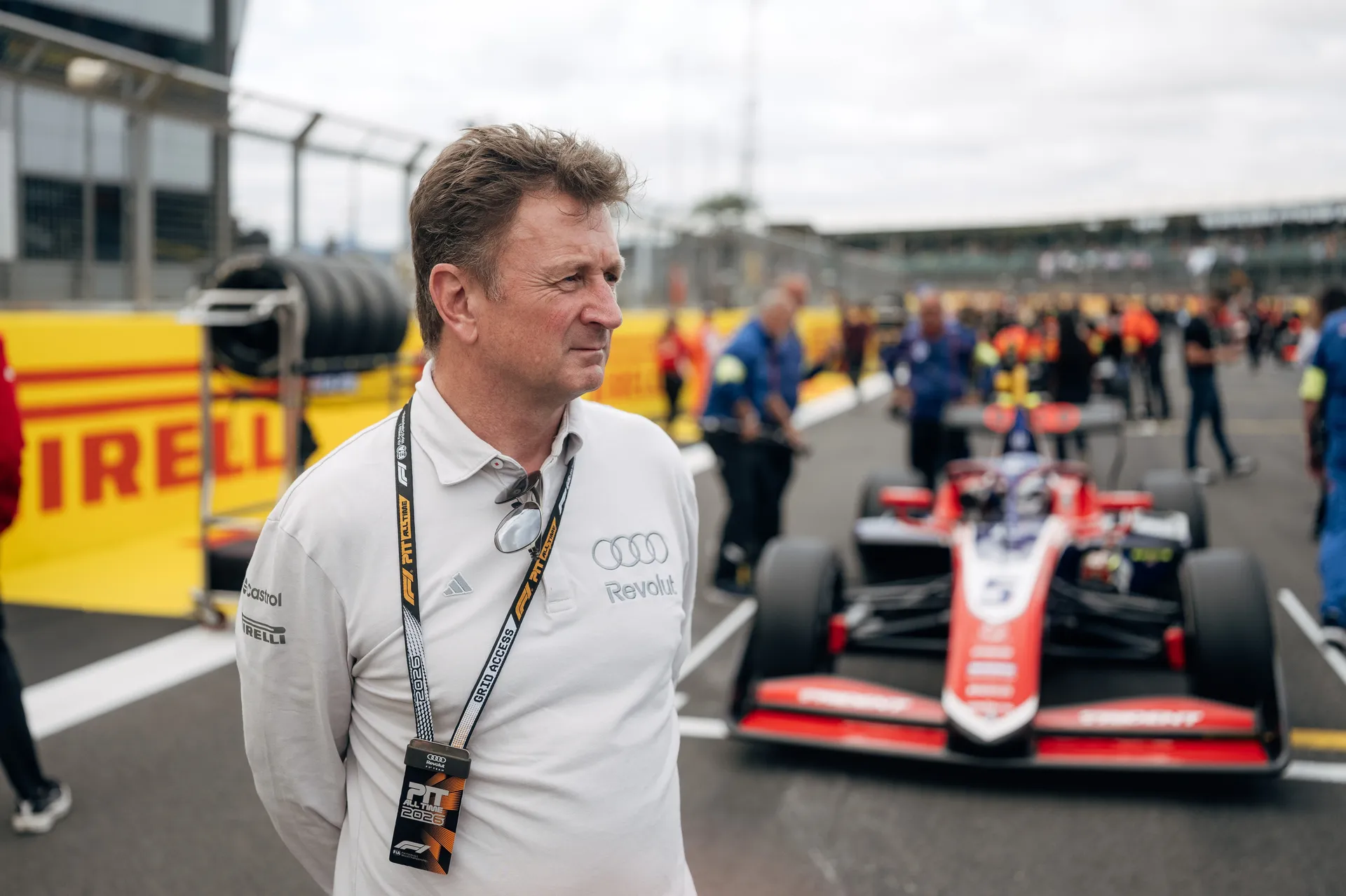 Allan McNish on the grid at Silverstone with an F3 car in the background, overseeing pre-race procedures as part of the Audi driver development programme.