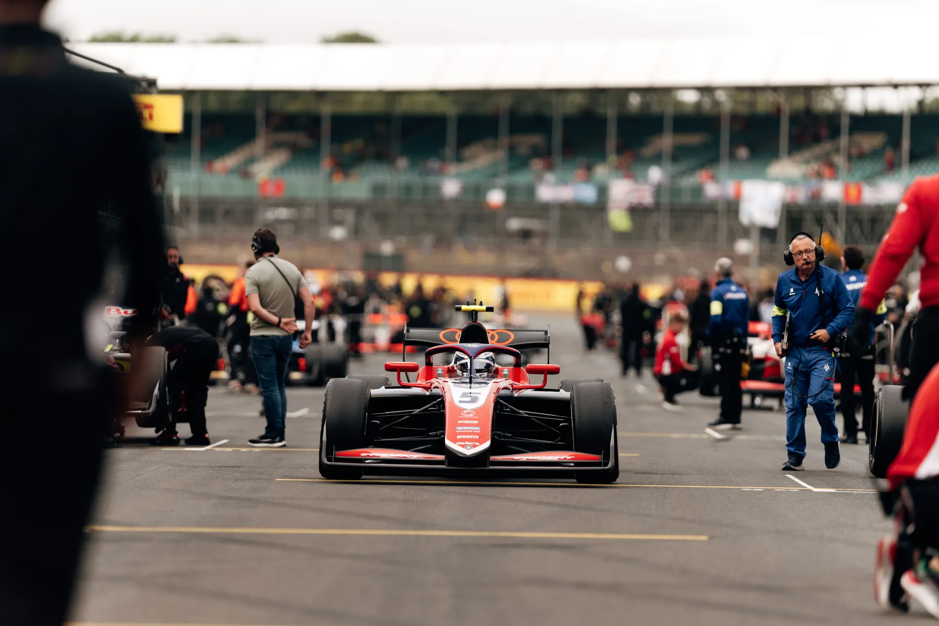 Freddie Slater’s Trident Formula 3 car is positioned on the Silverstone starting grid, with team personnel and other cars lined up in the background before the race.