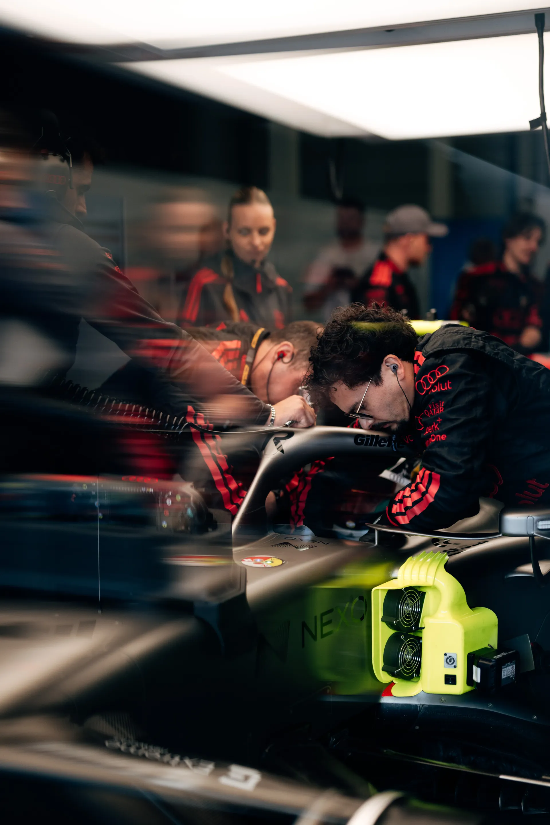 Audi Revolut F1® Team mechanics work closely on the R26 in the garage, making final adjustments before a Qualifying session.