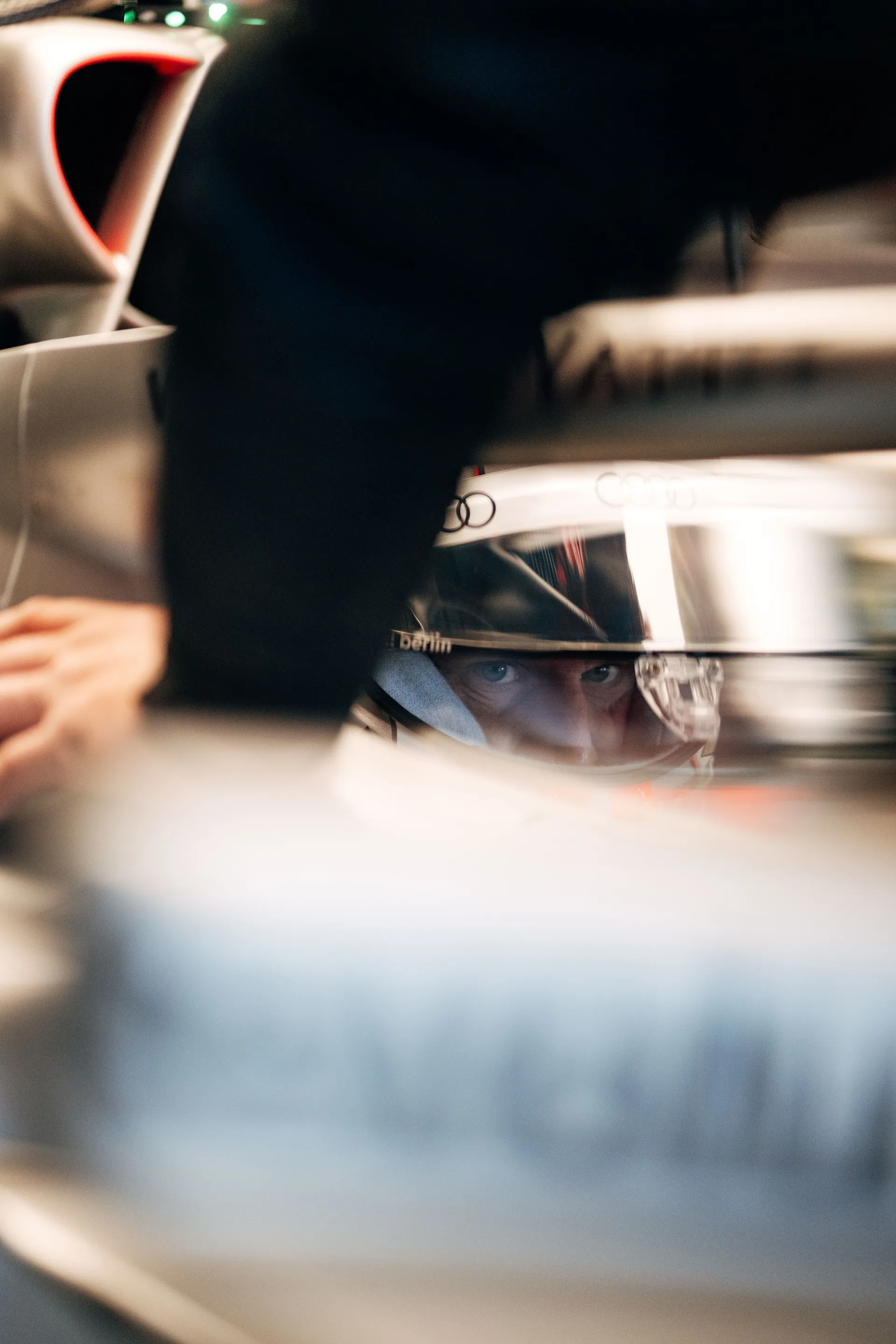 Close-up of a driver’s eyes through the visor inside the cockpit of the Audi R26, showing intense focus before heading out for Qualifying.