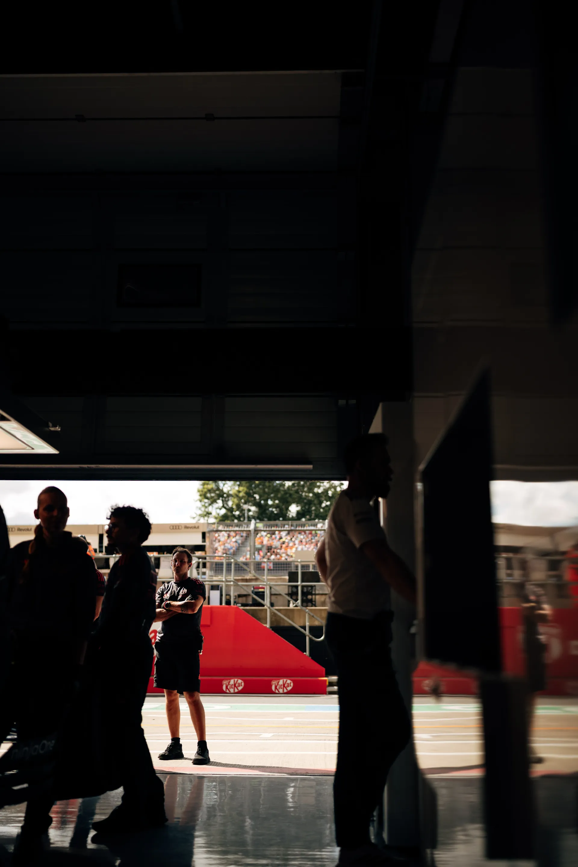 Wide shot of the Audi Revolut F1® Team garage with engineers, mechanics and leadership analysing data during Qualifying at Silverstone.