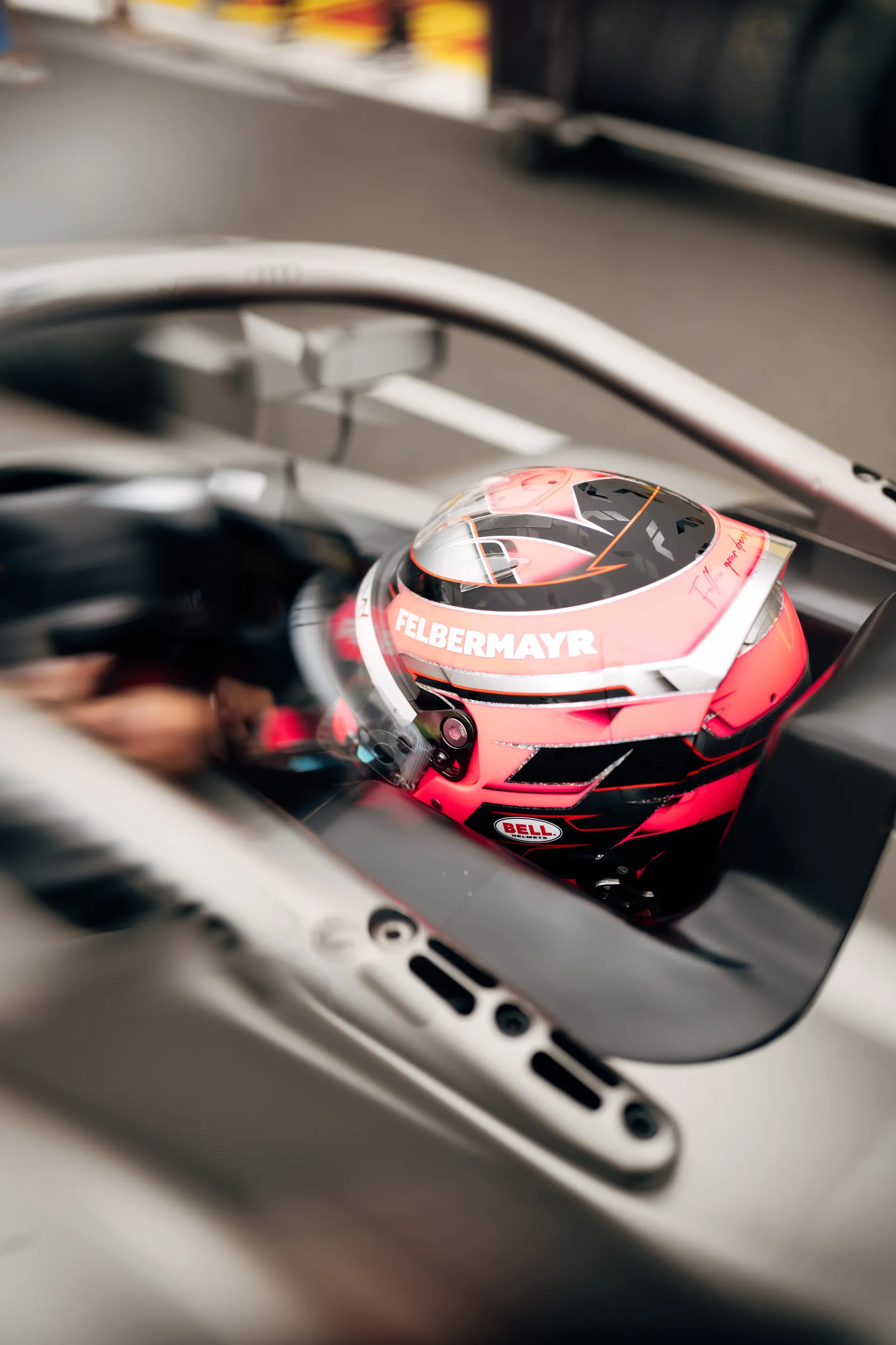 Emma Felbermayr’s pink helmet resting inside the cockpit of a single-seater race car.