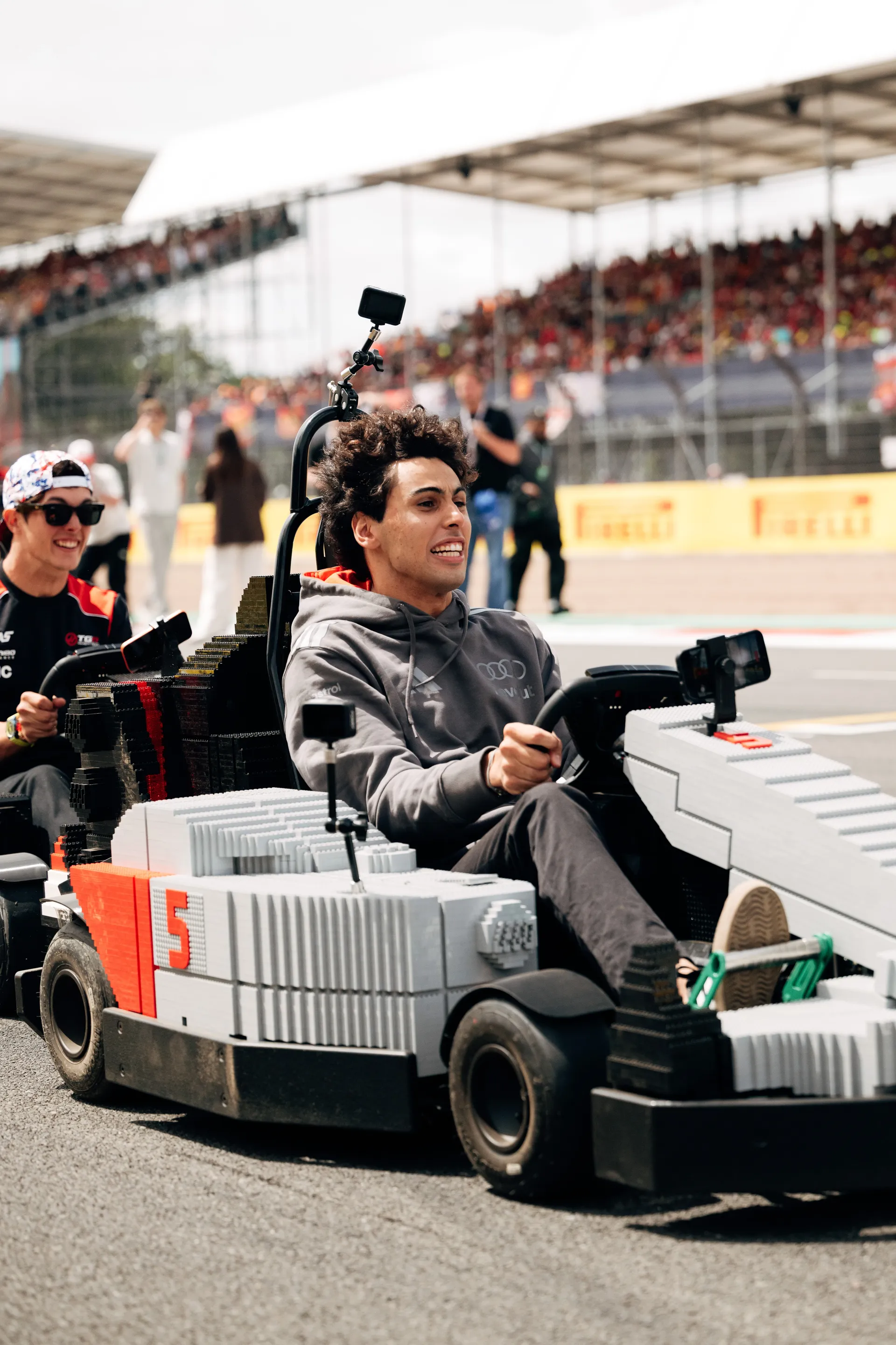 Close-up of Gabriel Bortoleto driving a LEGO® Audi R26 kart during the Drivers’ Parade, focused on the track at Silverstone.