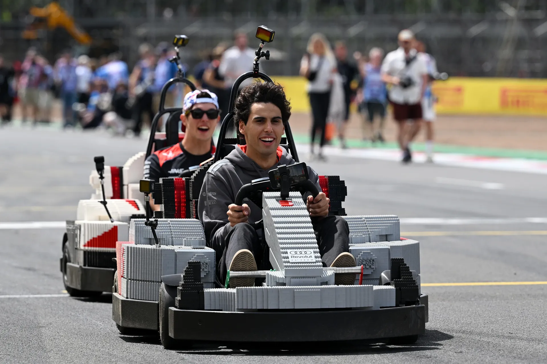 Gabriel Bortoleto driving an Audi R26 LEGO kart on track with another driver following behind during the Silverstone drivers’ parade.