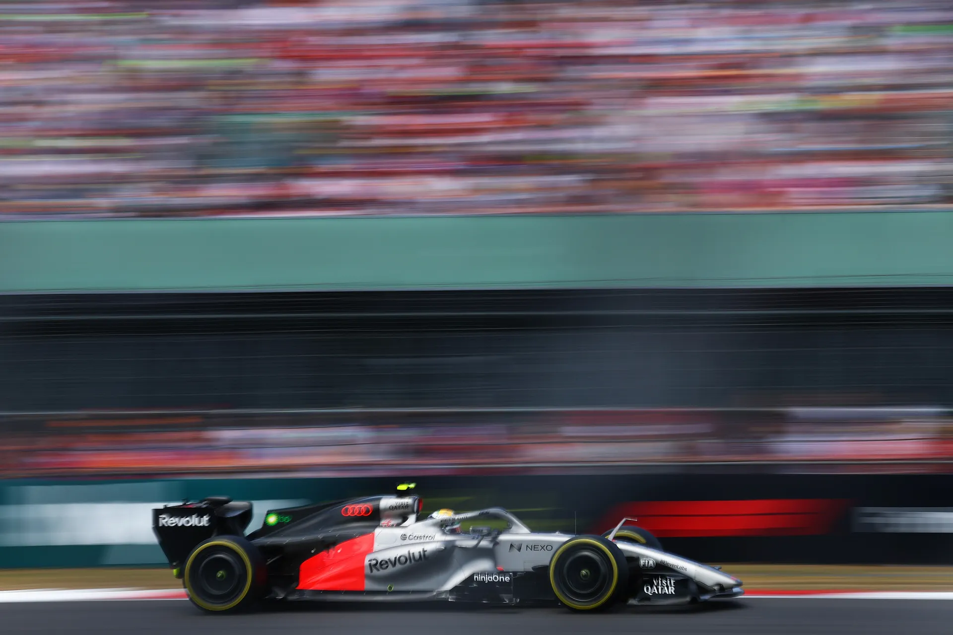 Audi Revolut F1® Team car driven by Gabriel Bortoleto captured in a high-speed panning shot with motion blur emphasising acceleration.