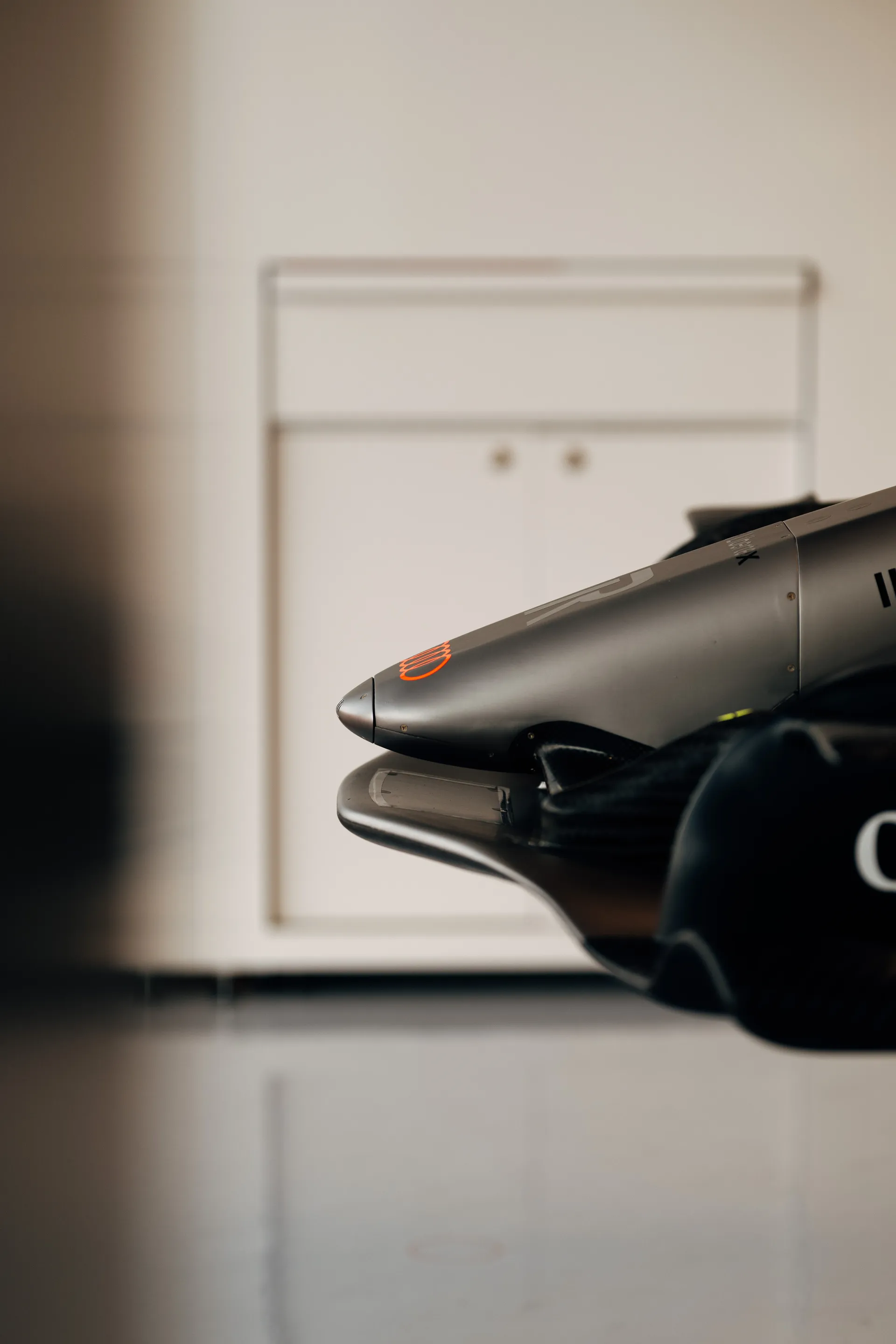 A mechanic from the Audi Revolut F1® Team adjusts an earpiece while preparing for on-track action.