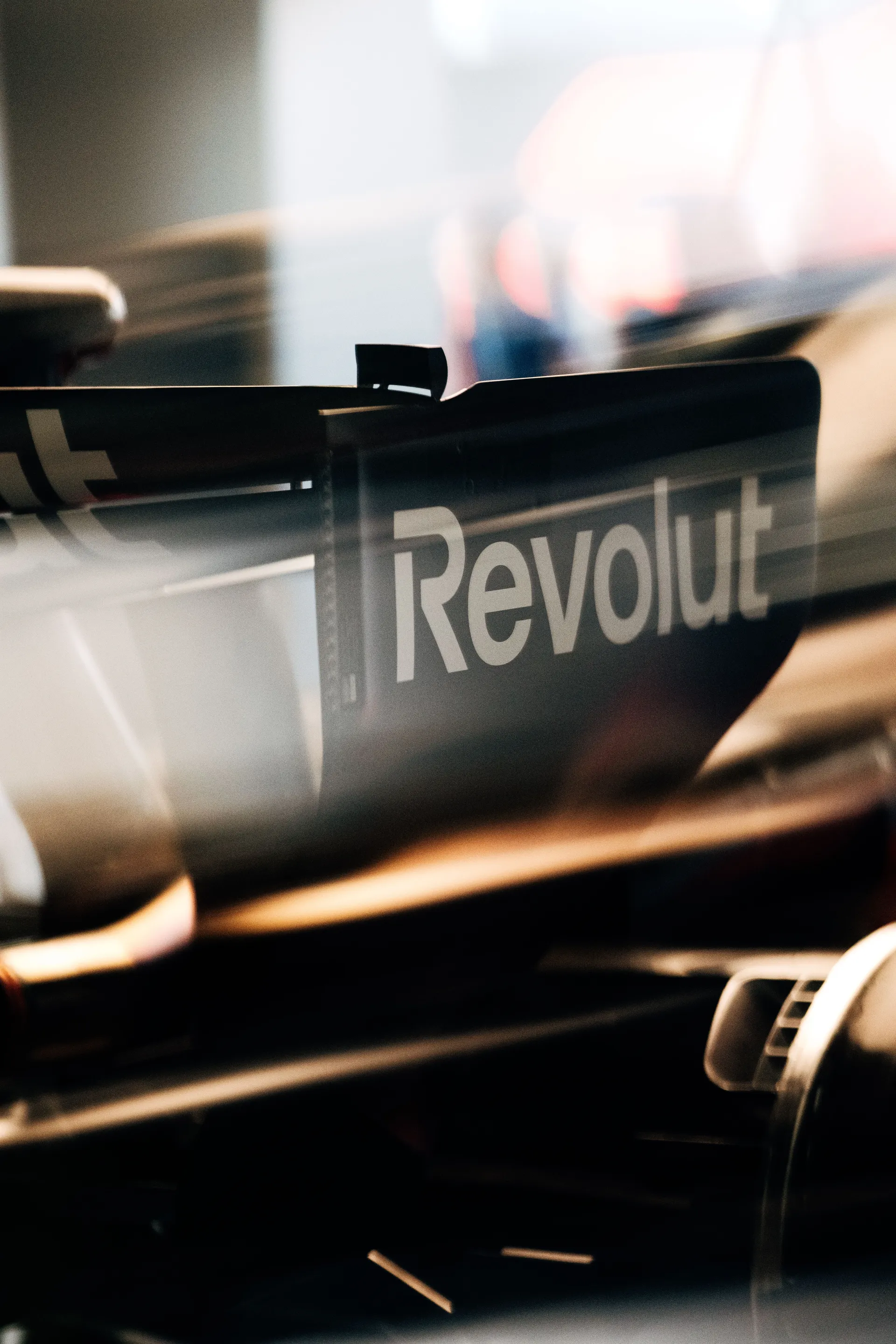 Close-up of the Audi R26 rear wing featuring Revolut branding inside the garage.