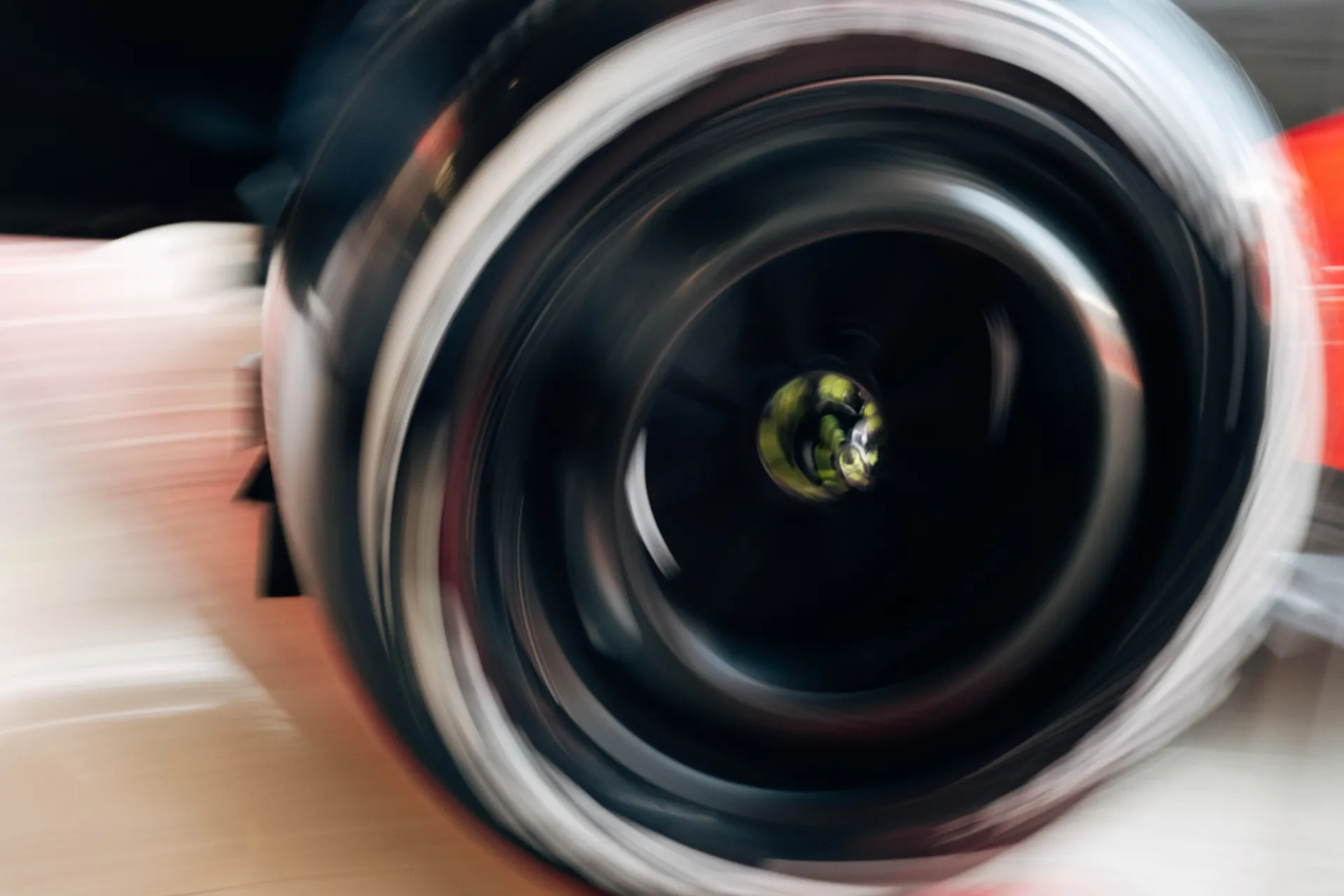 Extreme close-up of a spinning wheel on the Audi R26 creating a motion blur effect.