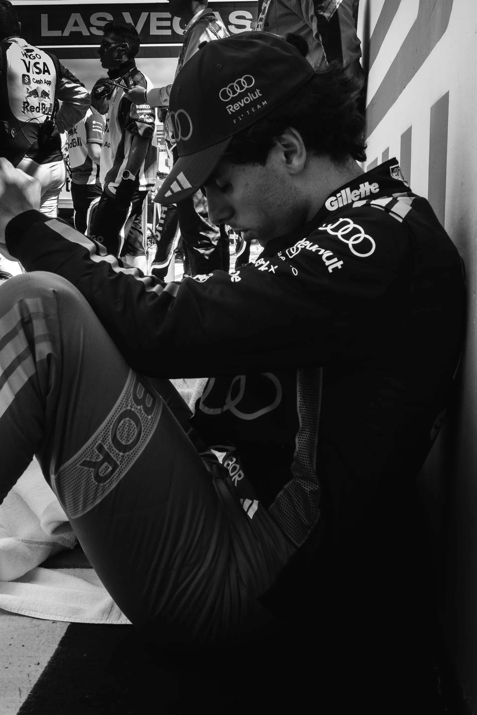 Gabriel Bortoleto sits alone in the garage area, head down in a moment of concentration ahead of the Sprint race at Silverstone.