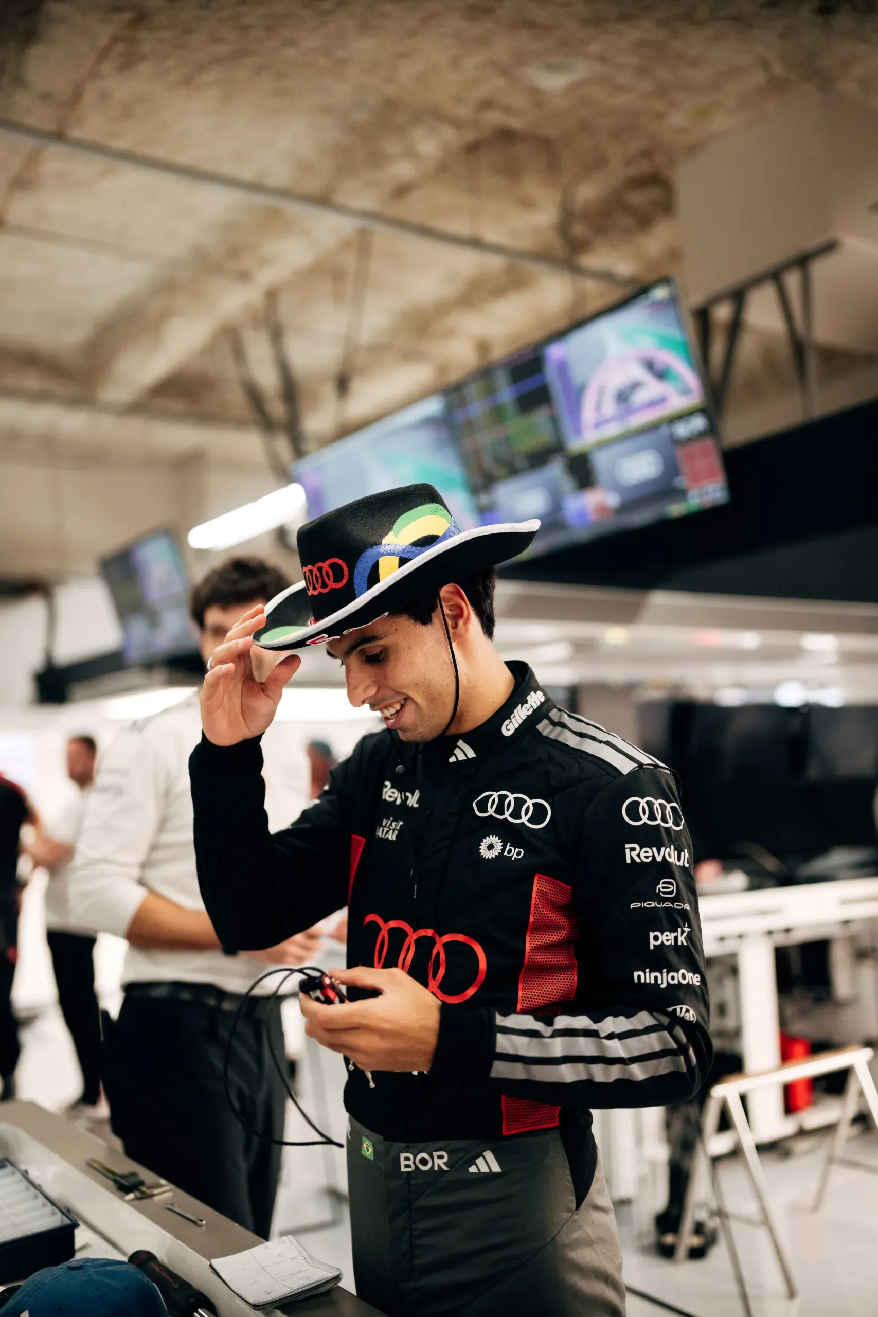 Audi Revolut F1® Team driver Gabriel Bortoleto tipping a cowboy hat in the garage at the USA Grand Prix